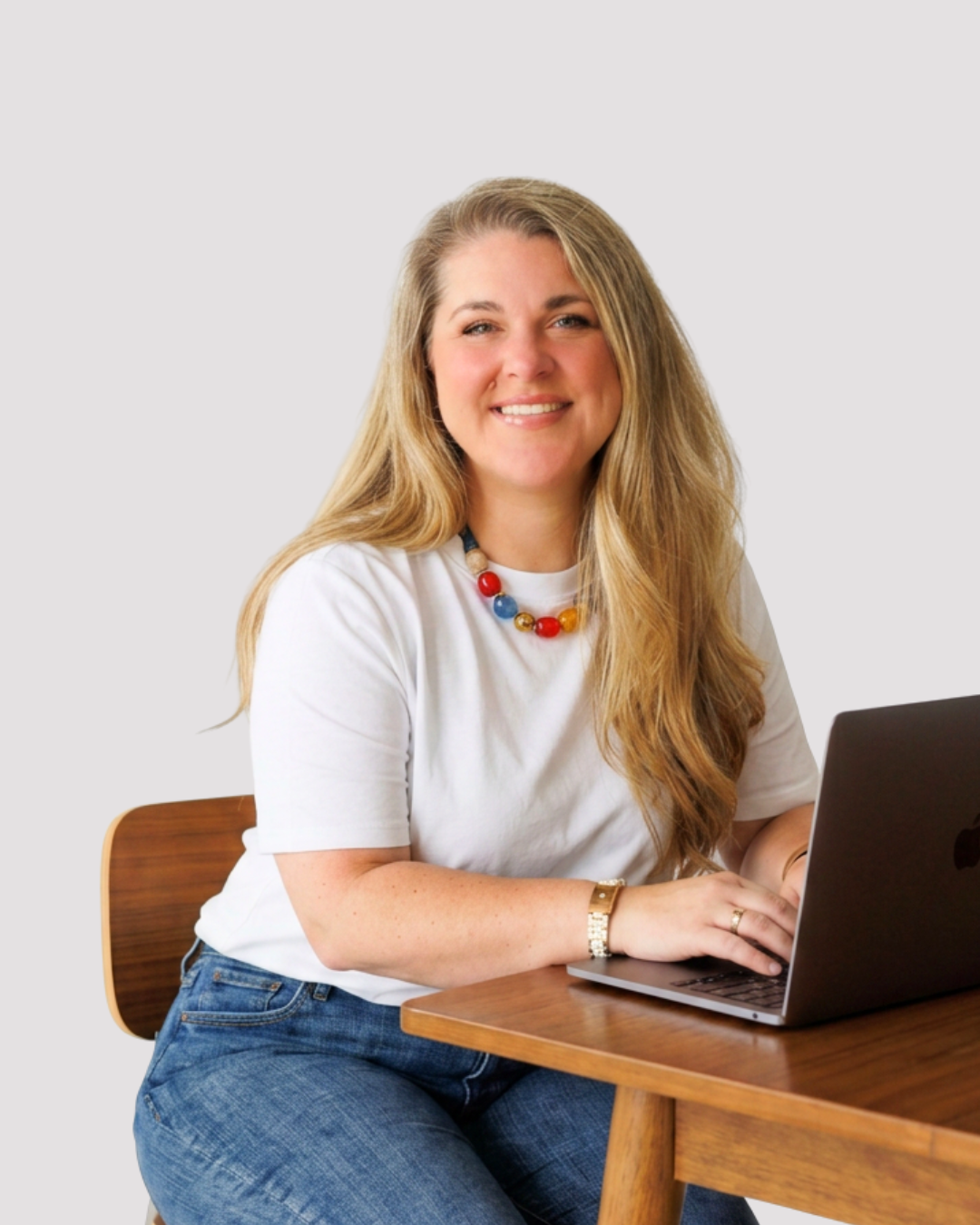 Brittany Shepard, freelance interior design writer and brand storyteller for home lifestyle publications sits at a desk typing