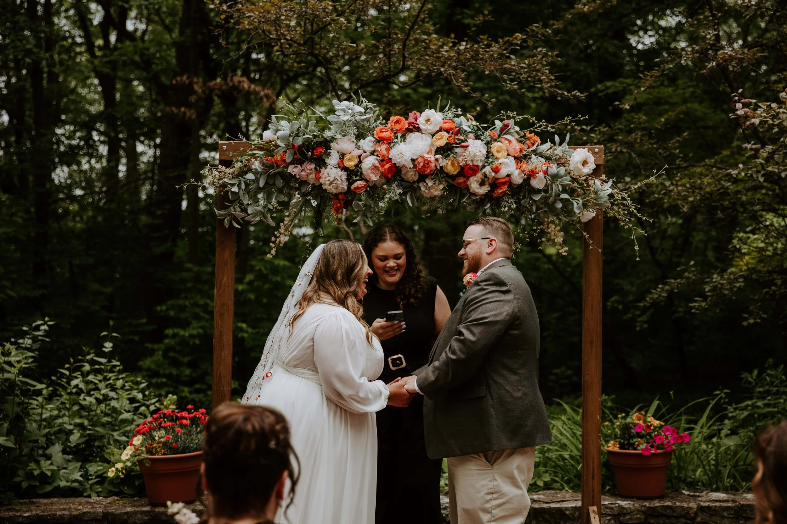 The bride and groom laugh during their ceremony.