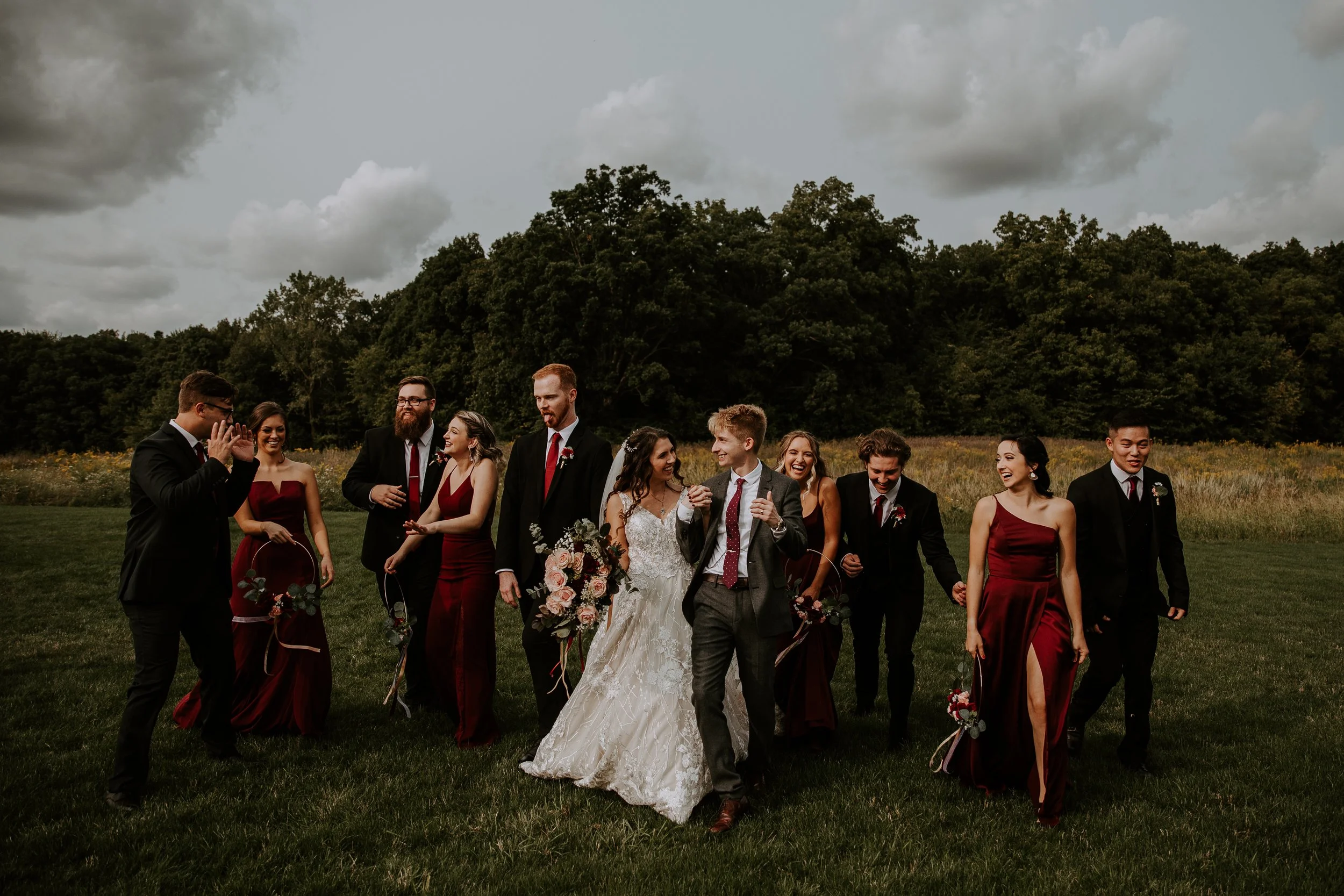 Bride and groom walking together with their wedding party, all smiling and chatting in a relaxed moment after the ceremony.