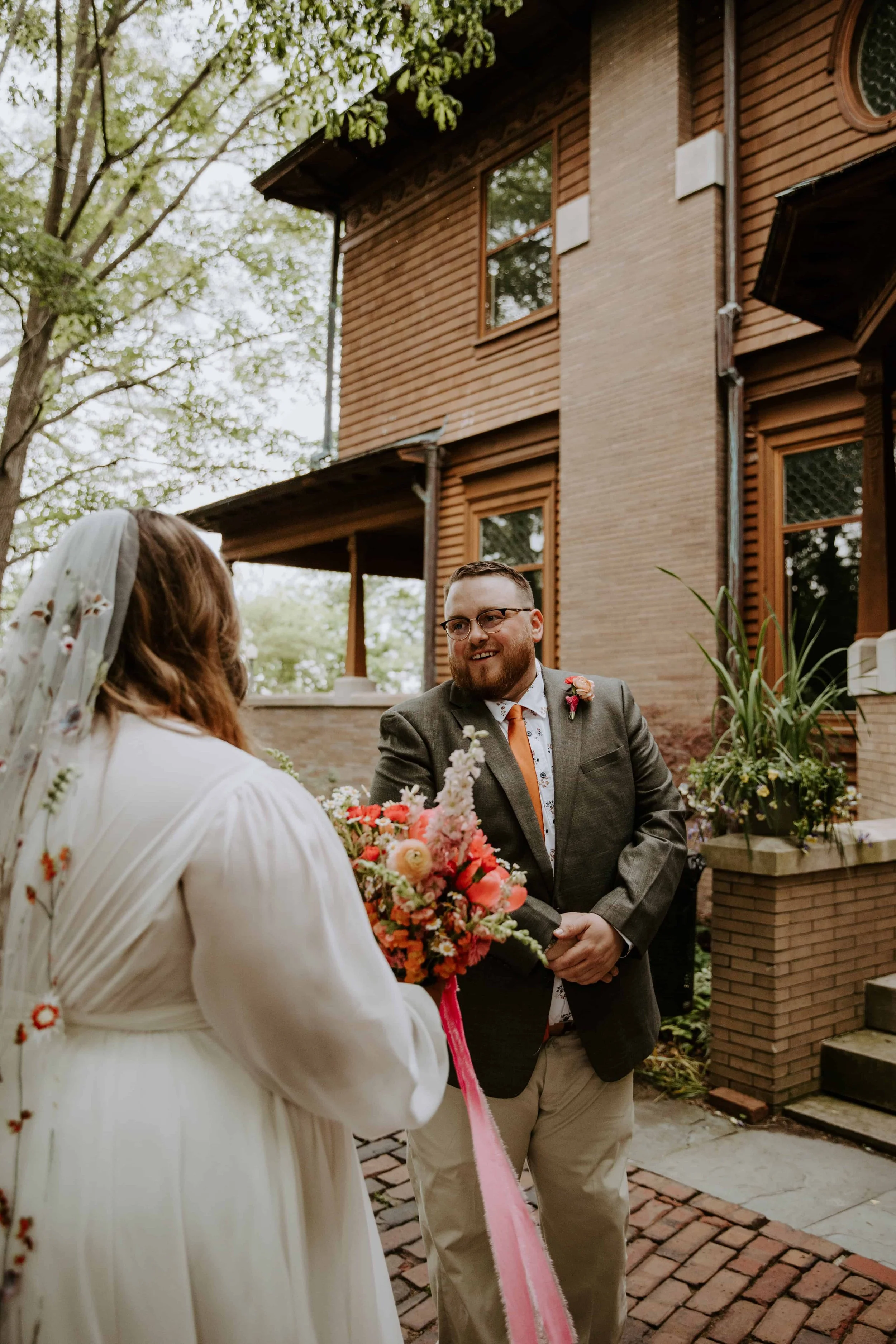The groom turns around to see the bride during their first look.