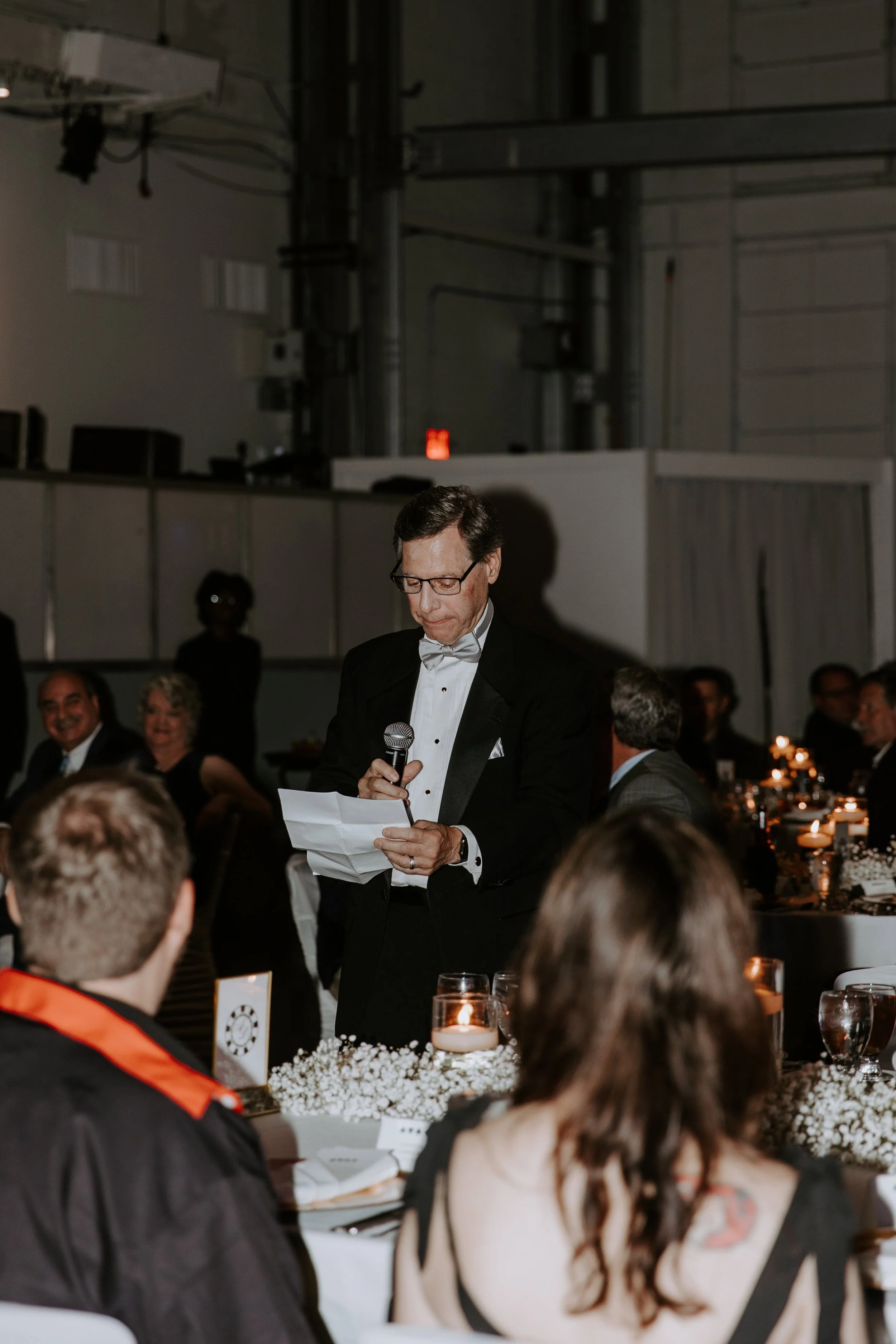 The bride's father makes a speech at the reception.