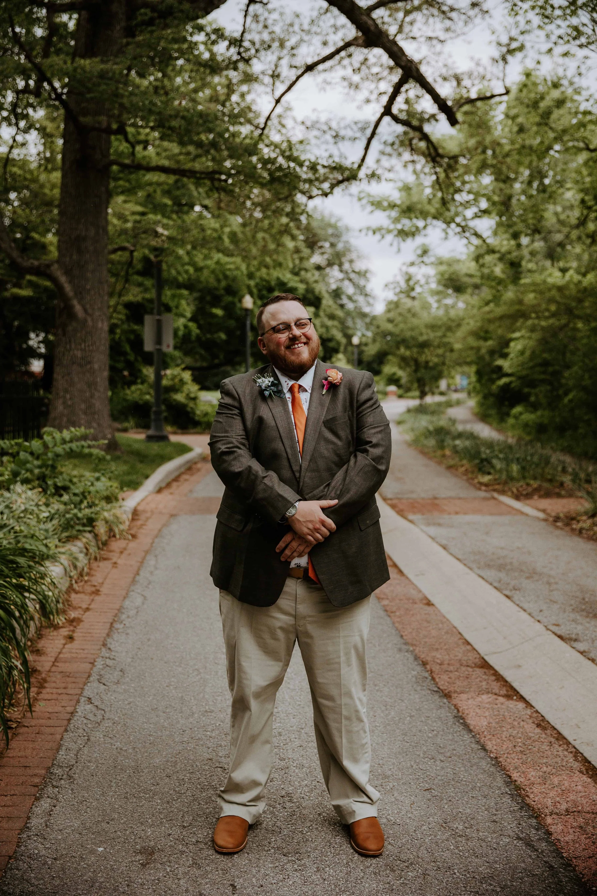 A full body portrait of the groom on Minnetrista Boulevard.
