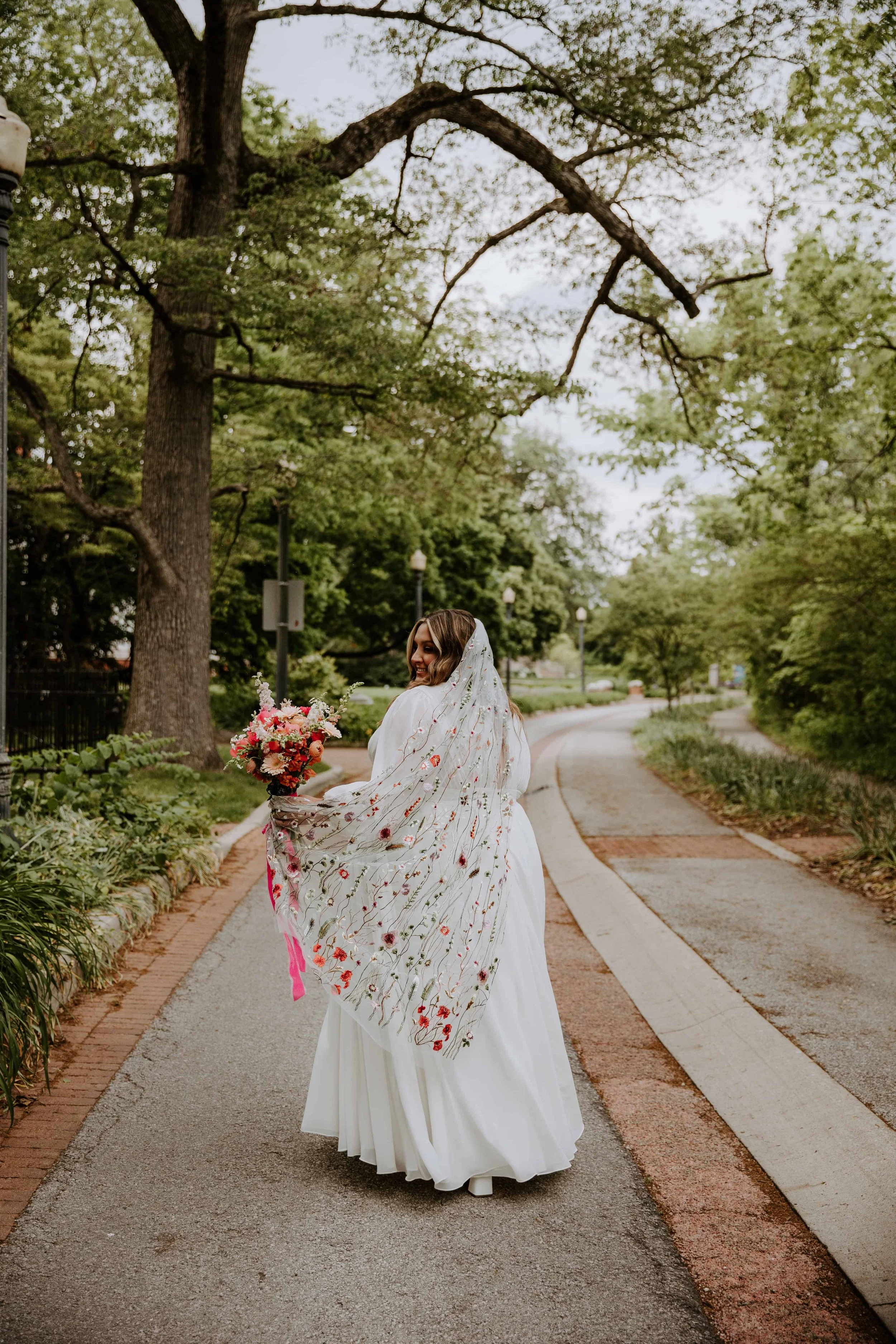 A full body portrait of the bride along Minnetrista Boulevard.