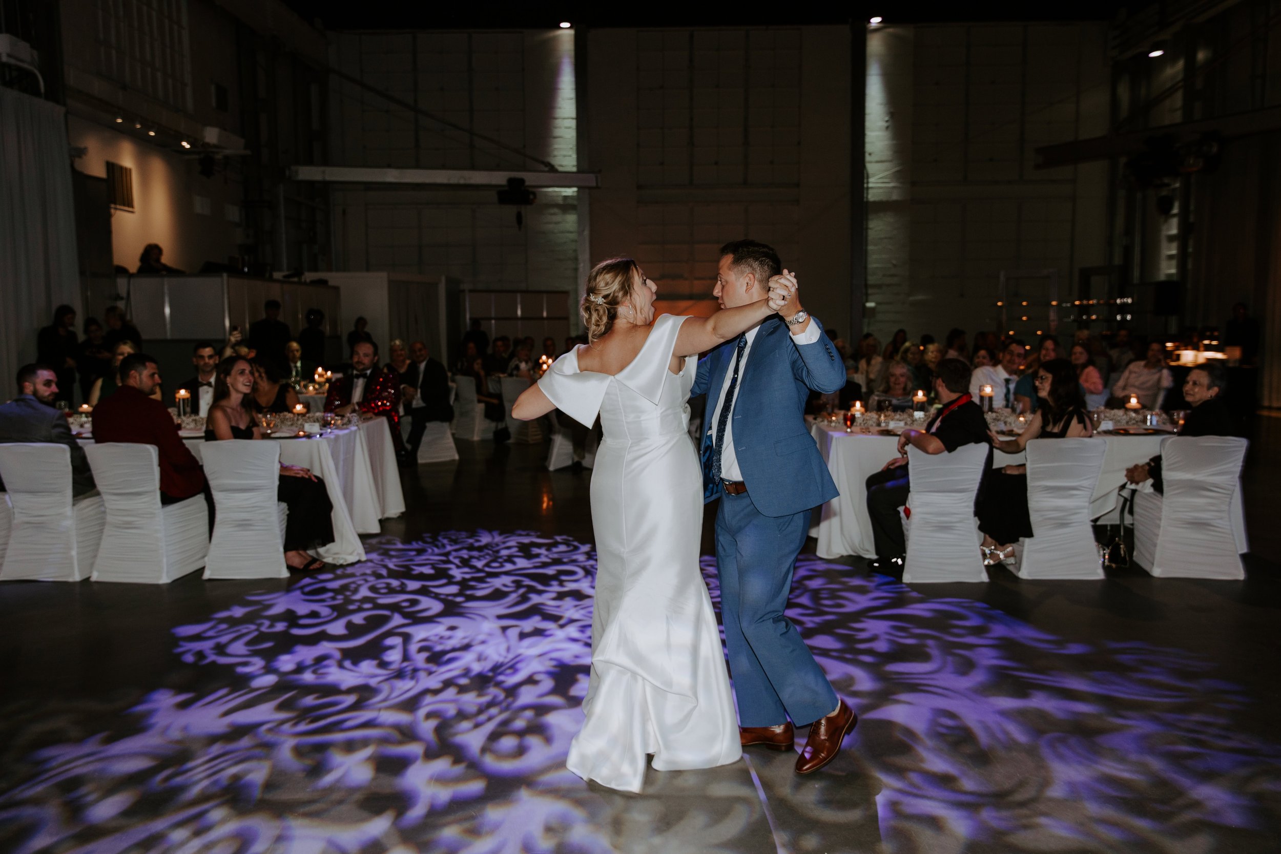 The bride and groom share their first dance surrounded by their family + friends at their reception.