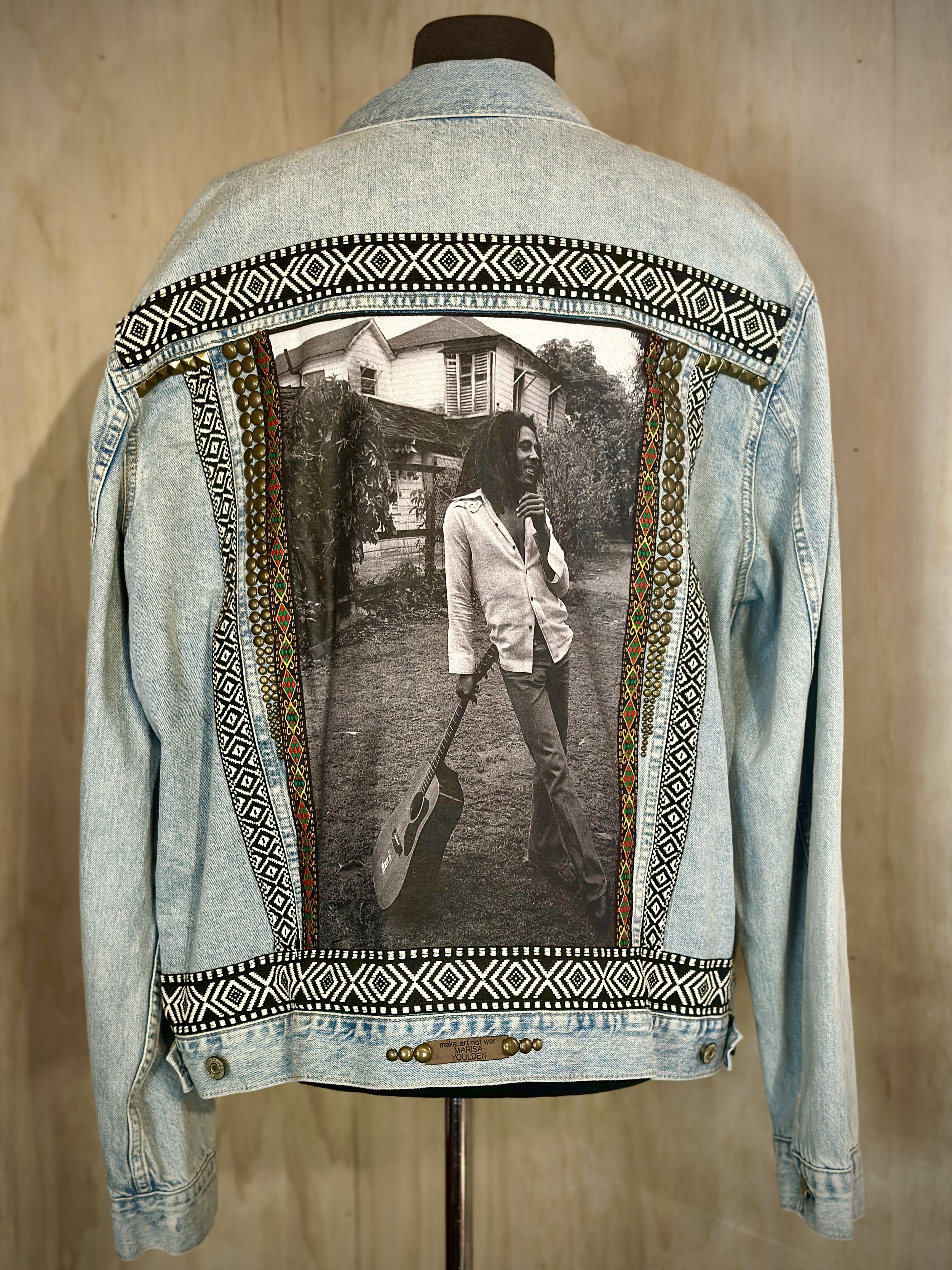 Denim jacket featuring a black-and-white photo and decorative patterns on the back