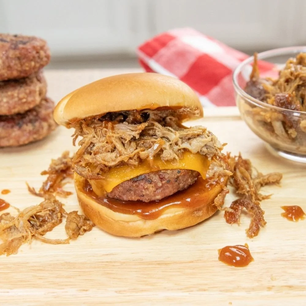 Fire up the grill it is time to assemble some delicious pulled pork burgers 🔥⁠
⁠
Perfect for feeding a crowd, these burgers are sure to be a hit at any gathering. Piled high with juicy pulled pork and your favorite toppings, they are simple to make 