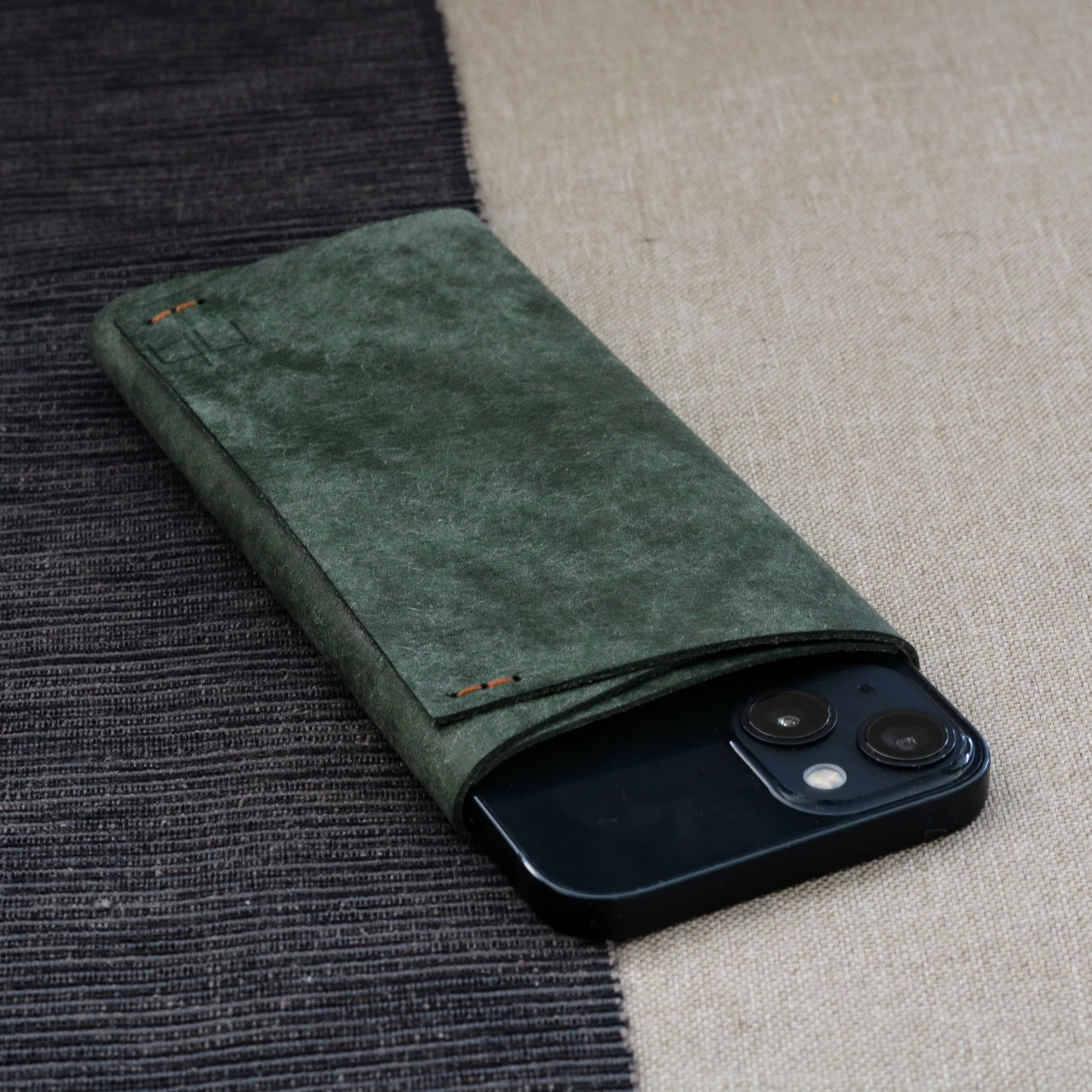 handmade iPhone 17 Max phone sleeve case. Handmade from premium dark green Italian leather. Compact folded design. Custom sizes for phones with protective bumper cases available.