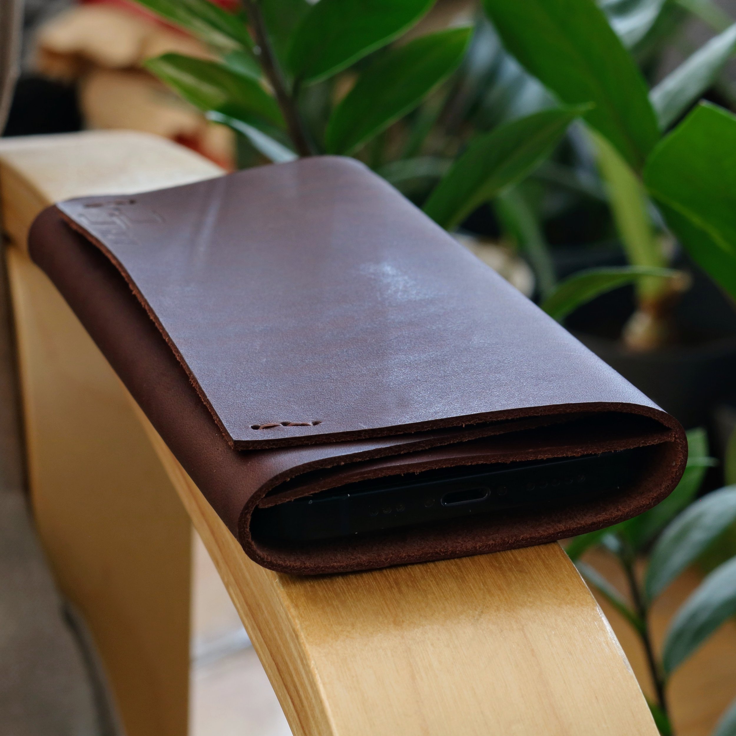Front view of smooth dark brown full grain leather Z Fold 8 folded pouch cover with brown stitching.