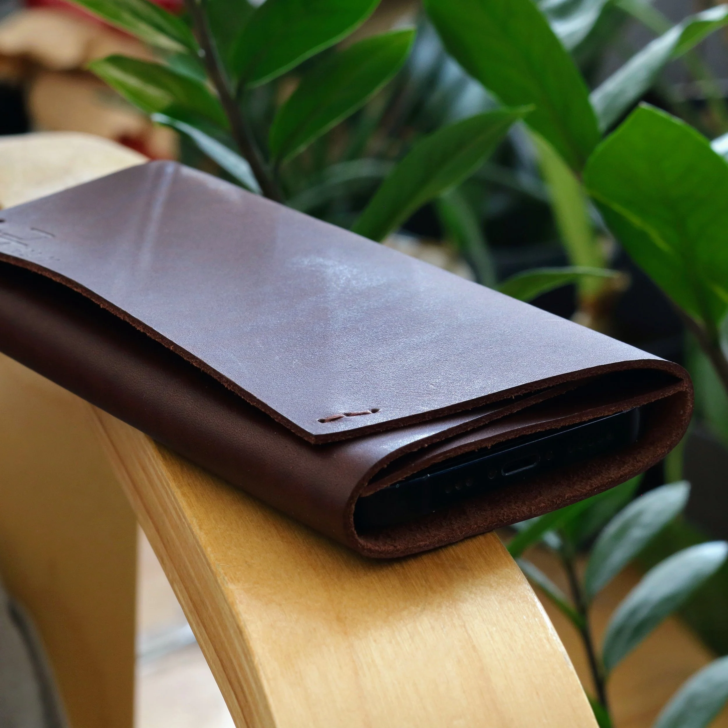 Side view of smooth dark brown Italian leather Z Fold 8 Ultra compact pouch cover with brown stitching.