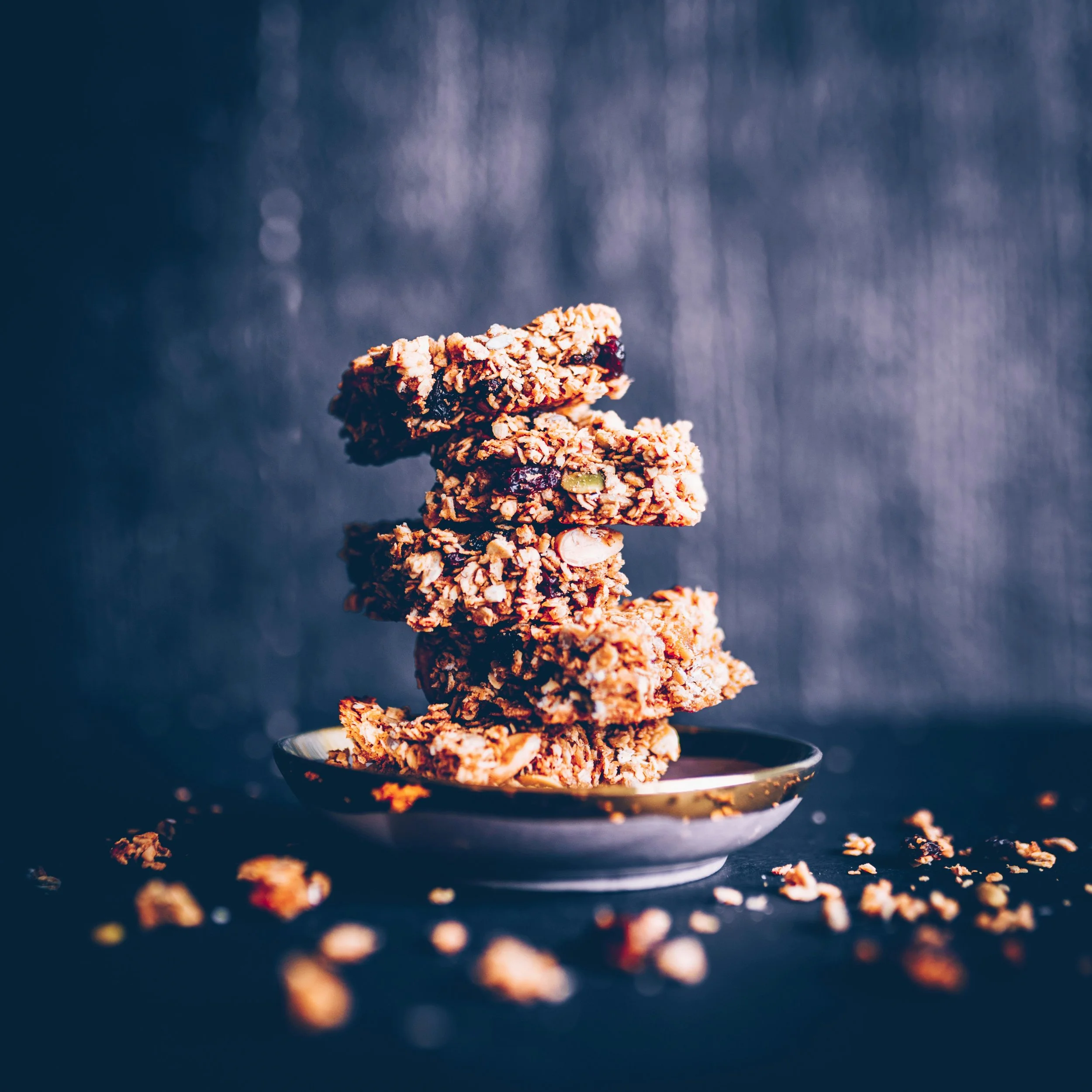 A stack of healthy protein bars on a plate with a dark blue background