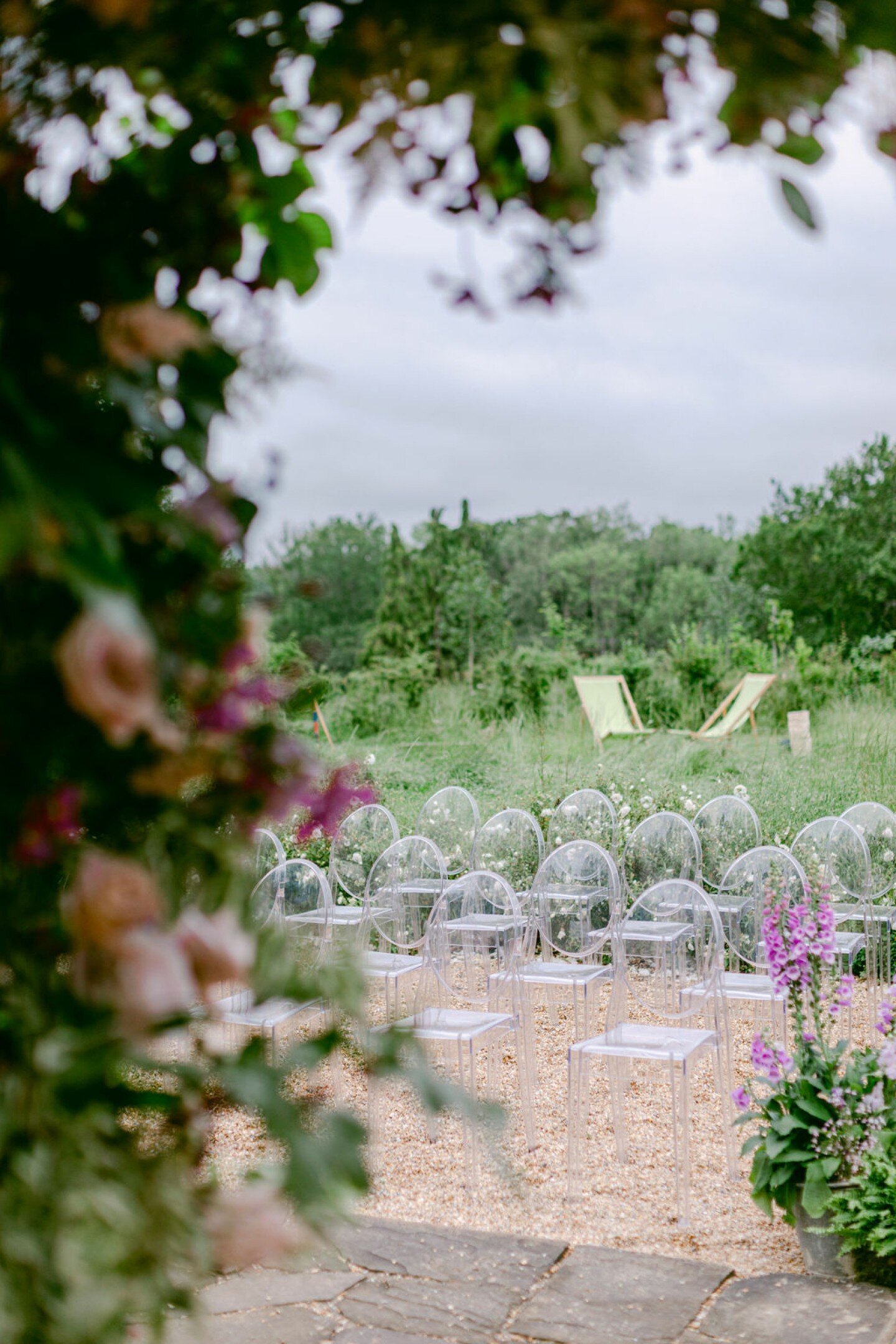 Our Ghost Chairs, with their transparent and ethereal design, add an element of modern elegance to outdoor settings like this stunning ceremony @ourbeautifulglasshouse. 

These versatile pieces of furniture perfectly complement the open aesthetic of 