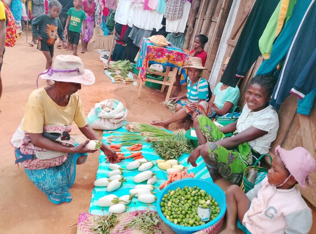 Marceline selling her produce at the market