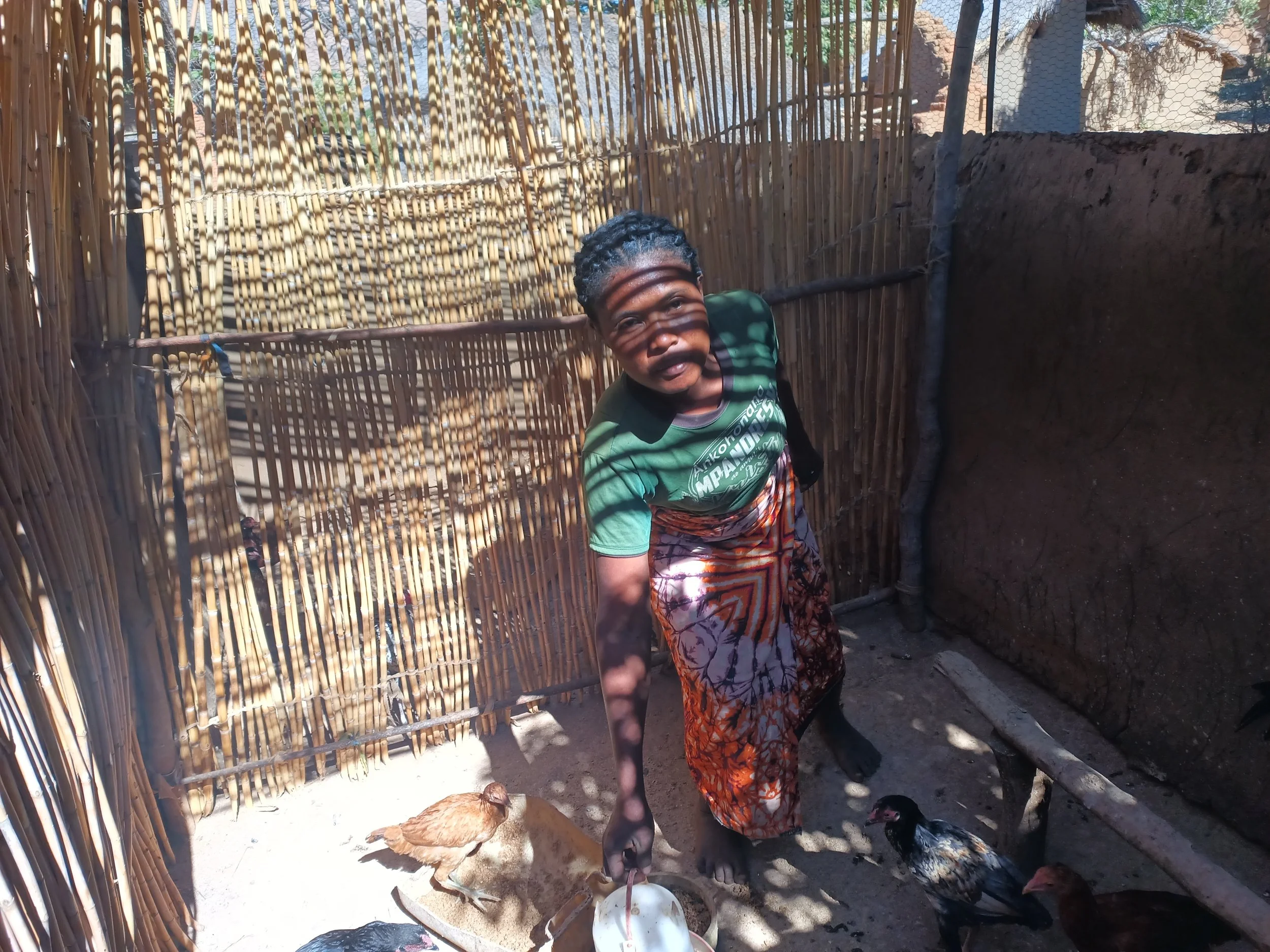Hanitra in the poultry yard with her chickens