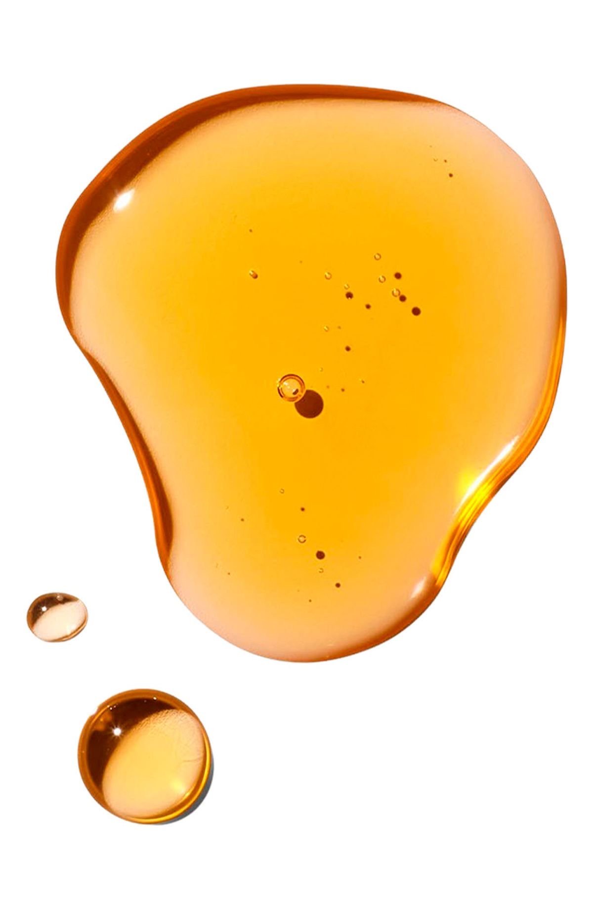 A small pool of Marula oil surrounded by some small droplets.