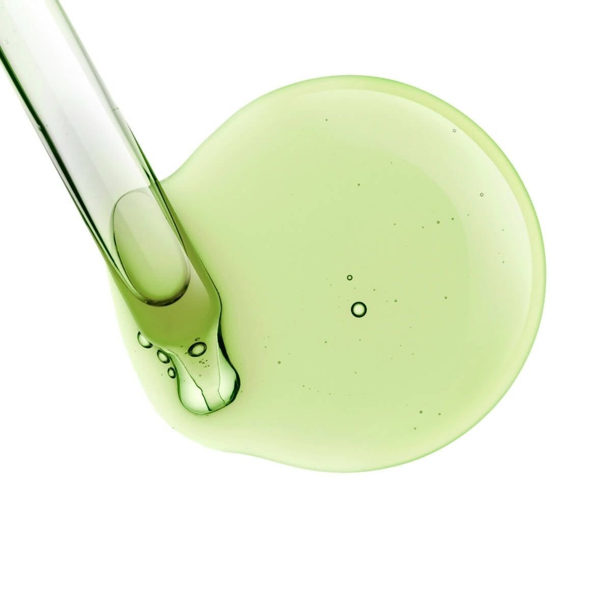 A small pool of radiant resilience facial serum next to an eyedropper.