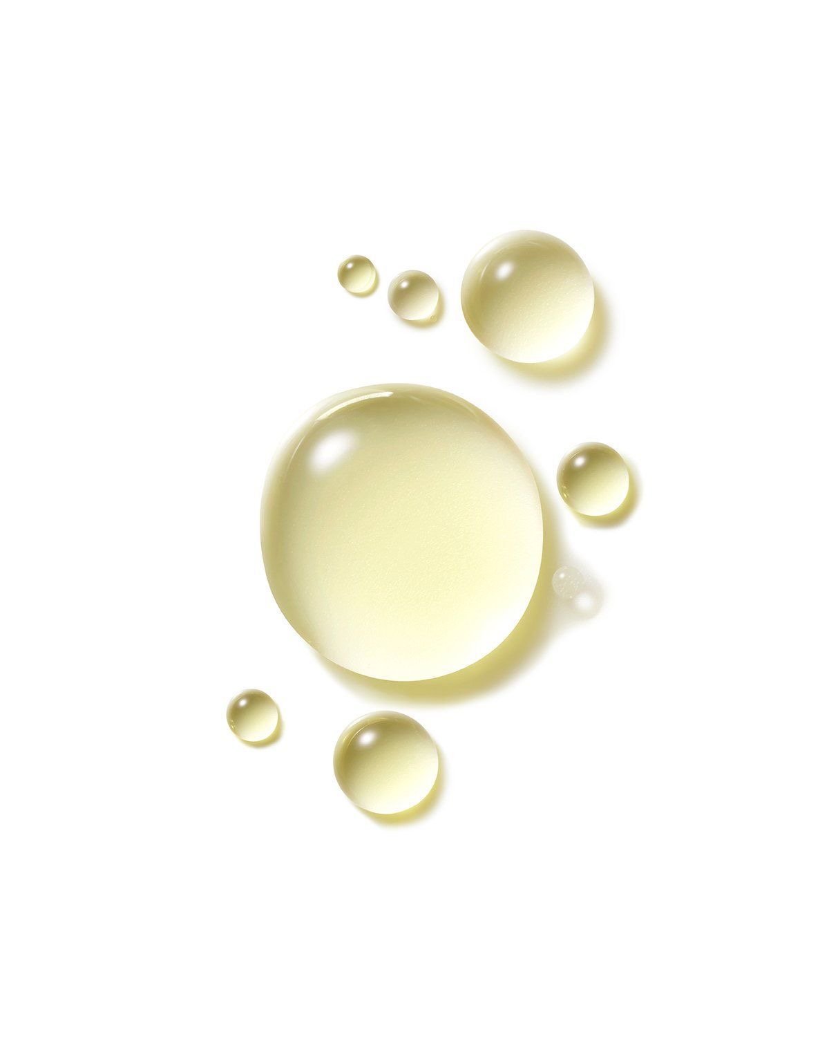 Small droplets of Kakadu plum oil against a white backdrop.