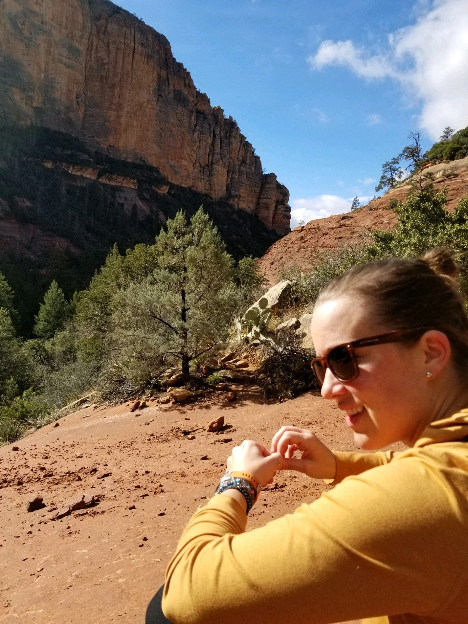 Tonia Johnson seated among the red rocks of Sedona.