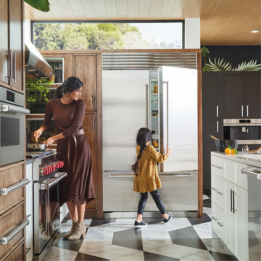 People in kitchen opening fridge