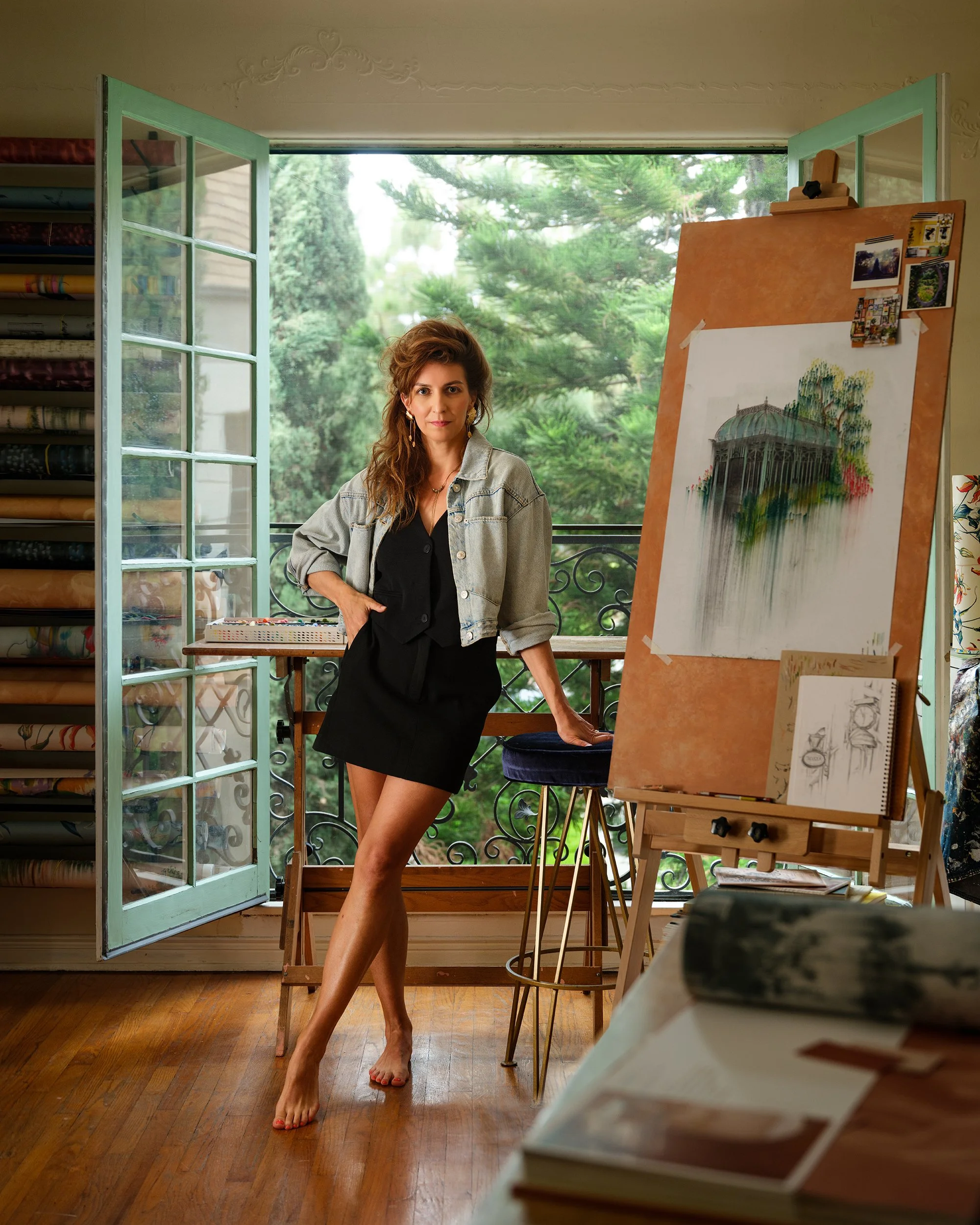 Portrait of Danica Adler in her LA studio, surrounded by original artwork from her wallpaper collections, photographed by Joseph Kramm