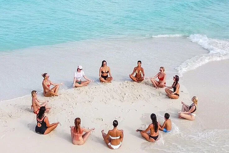 1000_group-meditating-circle-sandy-beach-1783446538.jpg