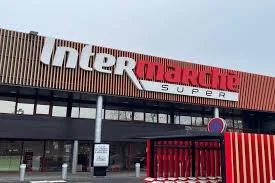 Exterior view of Intermarché supermarket with a red and white sign on a large building facade