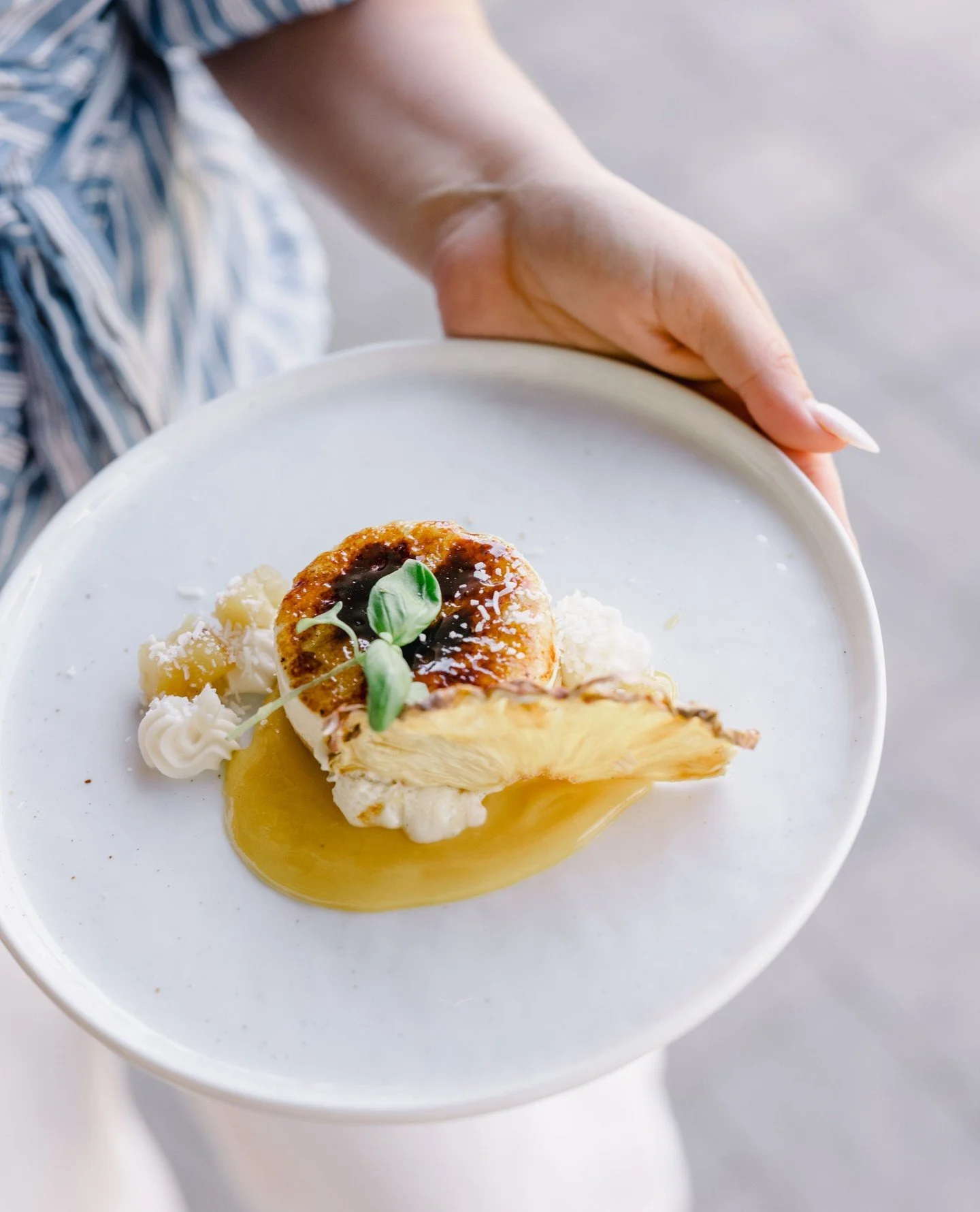 Our Cheesecake Br&ucirc;l&eacute;e has a perfectly caramelized br&ucirc;l&eacute;e topping with  passion fruit curd, pineapple confit, coconut snow &amp; fresh micro basil 🍍⁠
⁠
⁠
Venue: @ranchoguejitoweddings⁠
Photo: @saltandsolstudios⁠
⁠
⁠