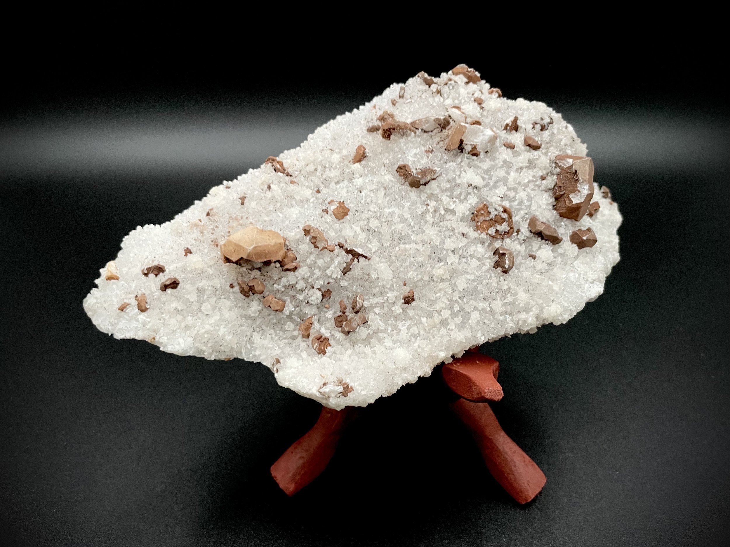 Guanajuato calcite on amethyst crystal cluster on wooden stand, luxury décor in Dallas showroom