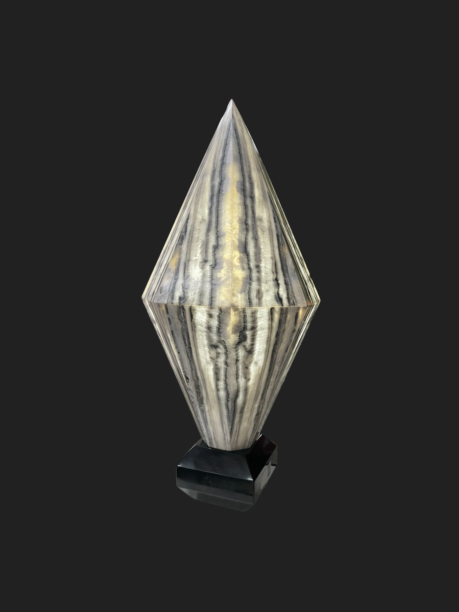 Close-up of banded black and gold onyx veining in table lamp