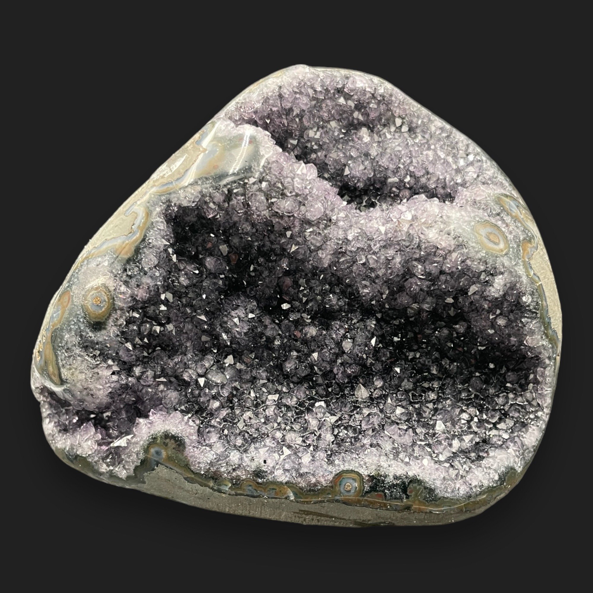 Natural amethyst geode sculpture with exposed druzy crystals and polished outer surface