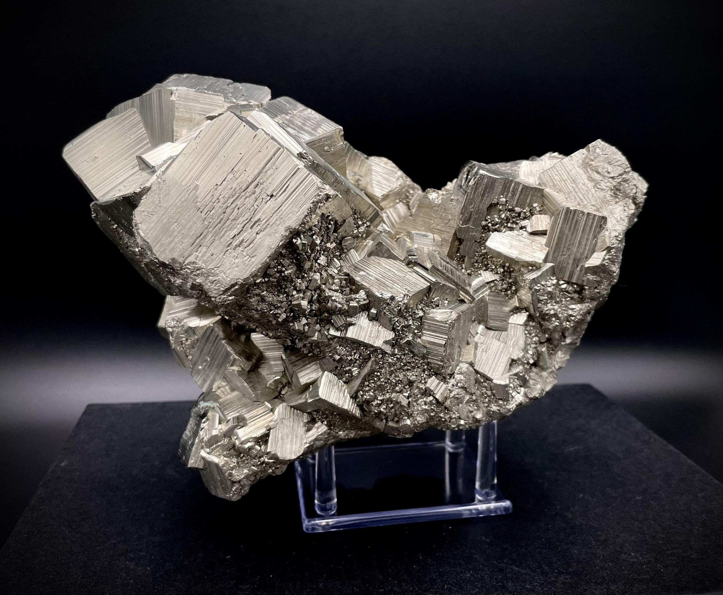 Cubic fortress pyrite cluster on acrylic stand, luxury mineral décor in Dallas showroom