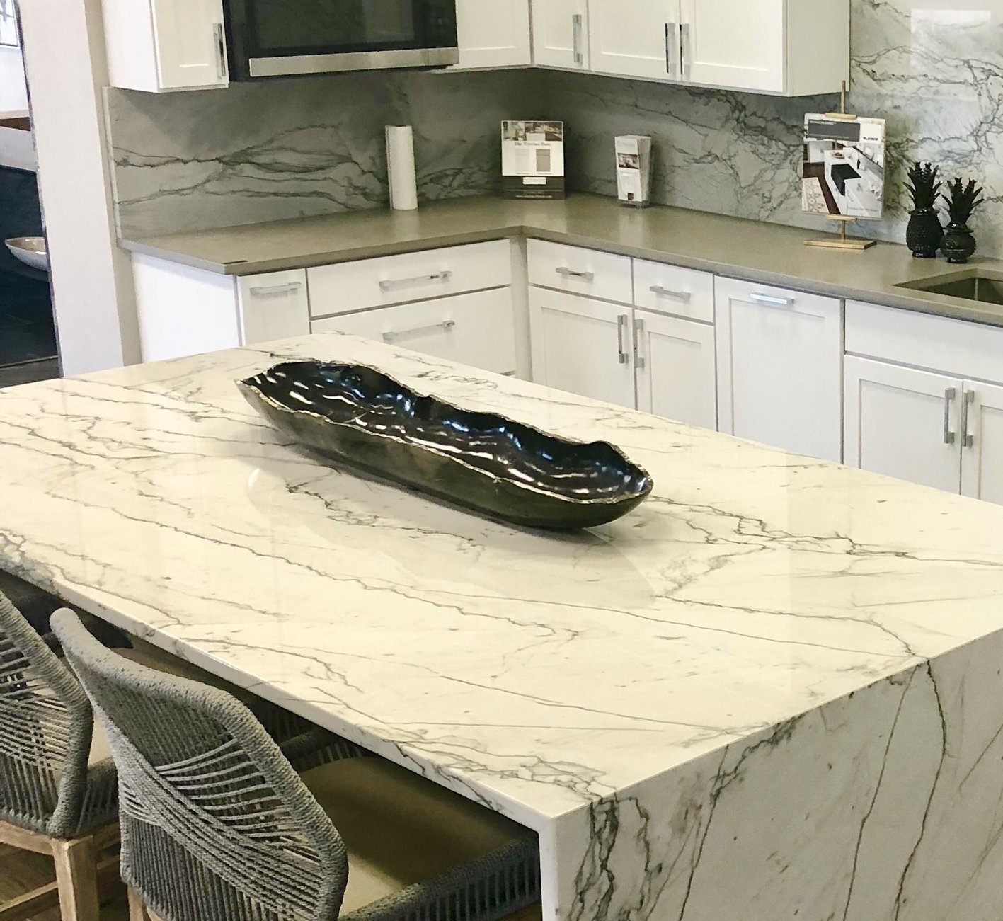 Obsidian Drift black stone bowl styled on a marble kitchen island