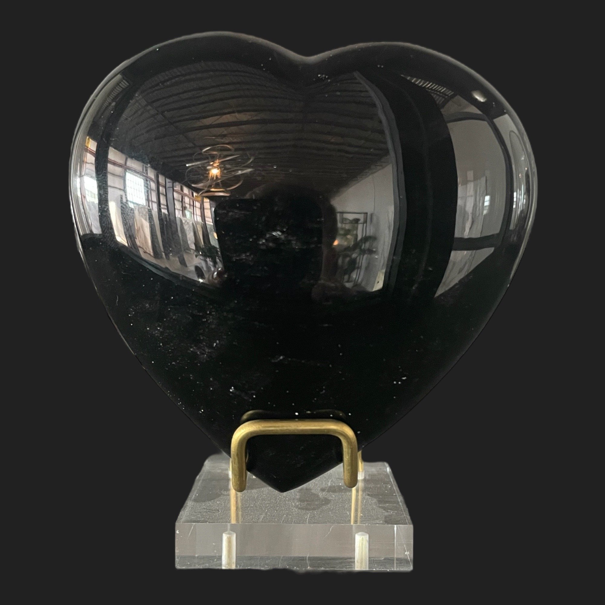 Polished black obsidian heart on acrylic and brass stand