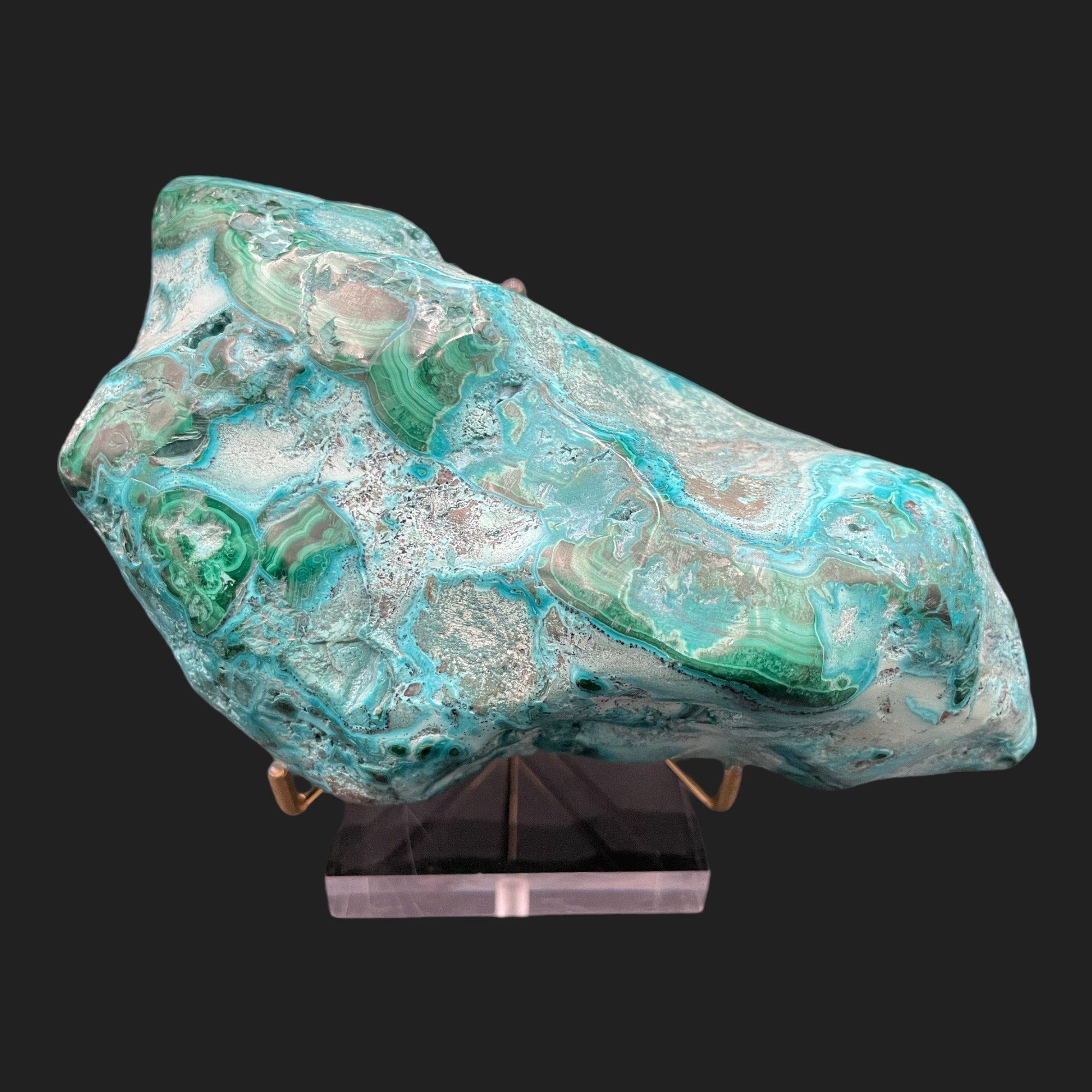 Polished chrysocolla malachite specimen on acrylic stand with swirling turquoise and green patterns