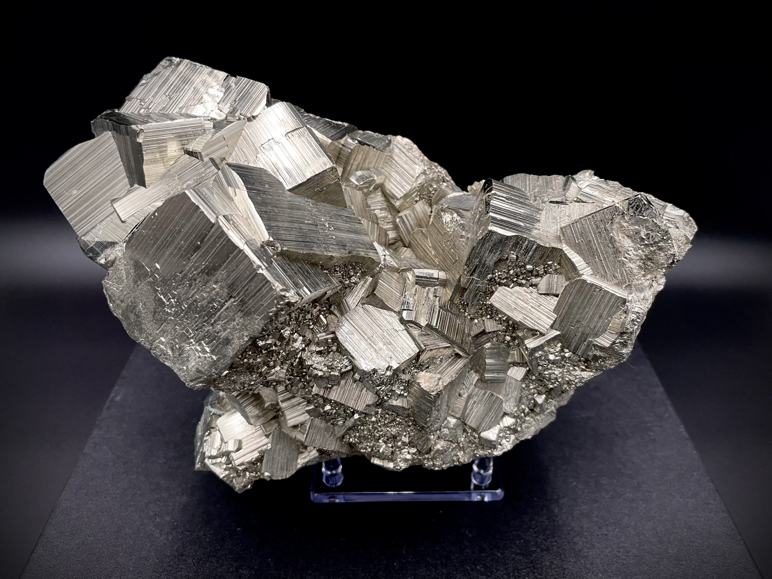 Cubic fortress pyrite cluster on acrylic stand, luxury mineral décor in Dallas showroom