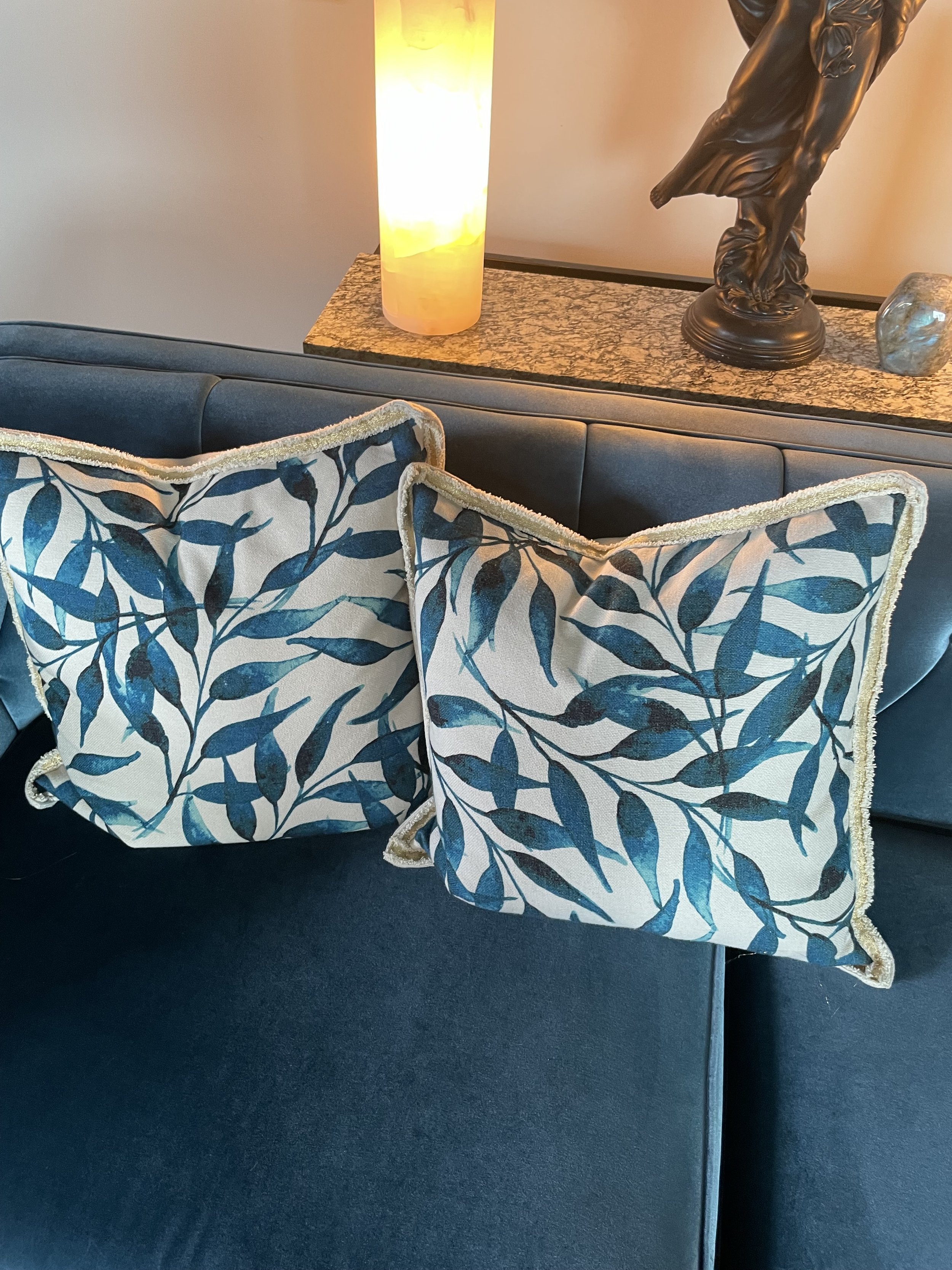 Blue velvet tufted sofa with walnut legs in modern living room