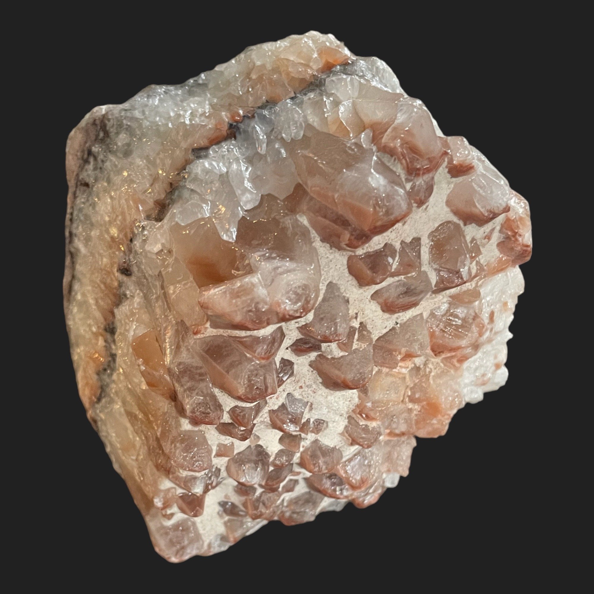 Rainbow Calcite crystal cluster showing clear and reddish-brown banding