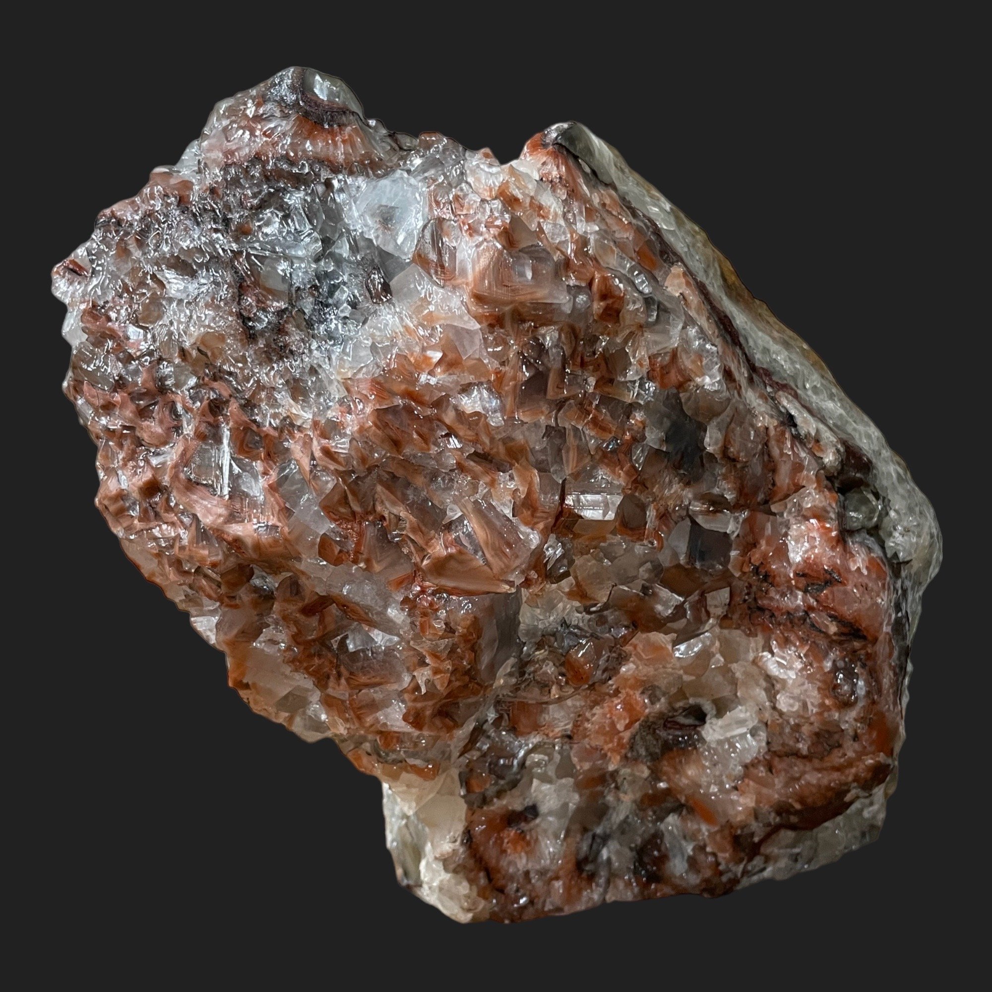 Rainbow Calcite crystal cluster showing clear and reddish-brown banding