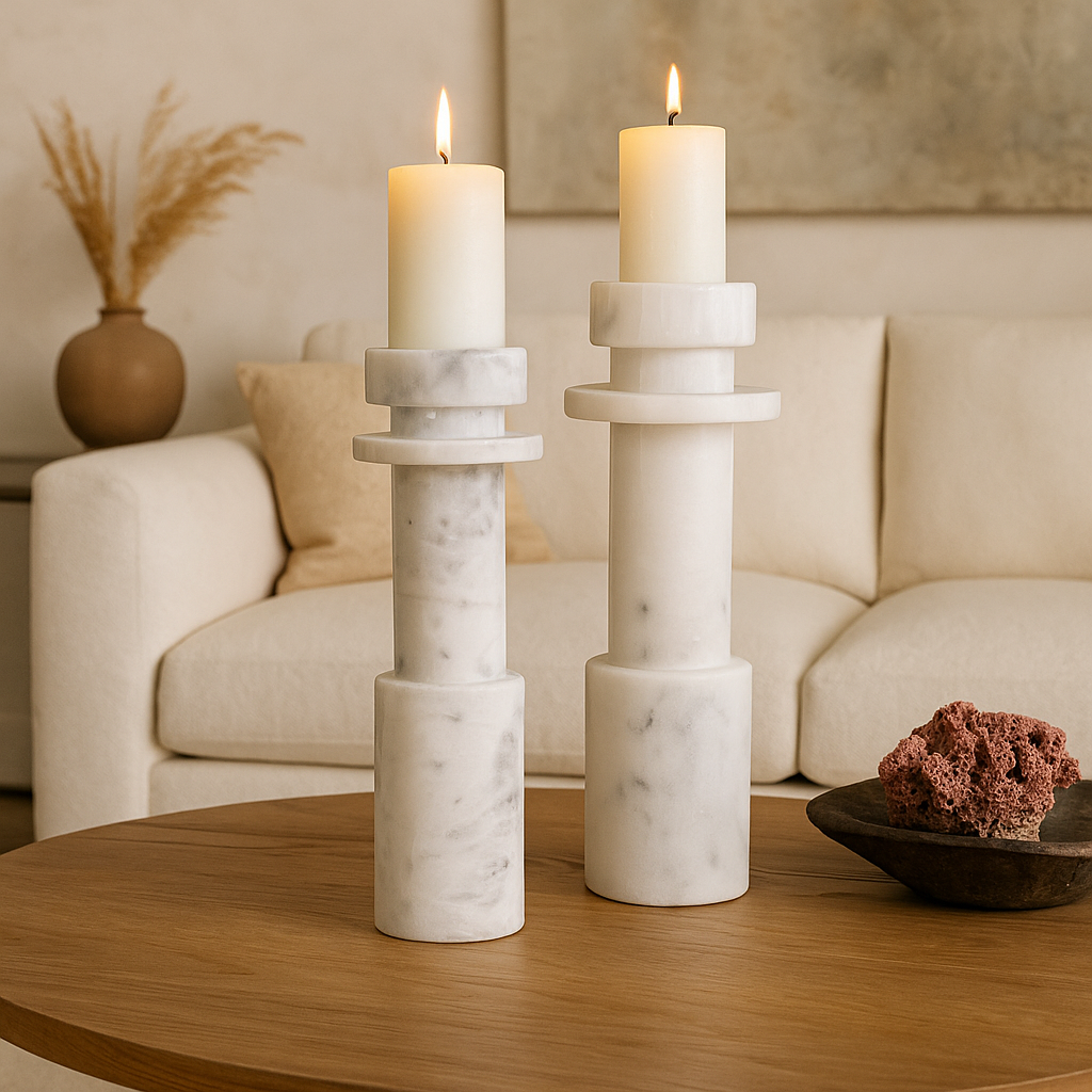 Pair of tall white marble pillar candle holders on wood coffee table in Dallas living room