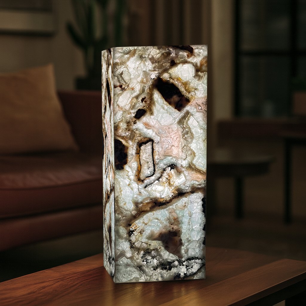 Tall blue-fluorite table lamp glowing on quartz vanity surface