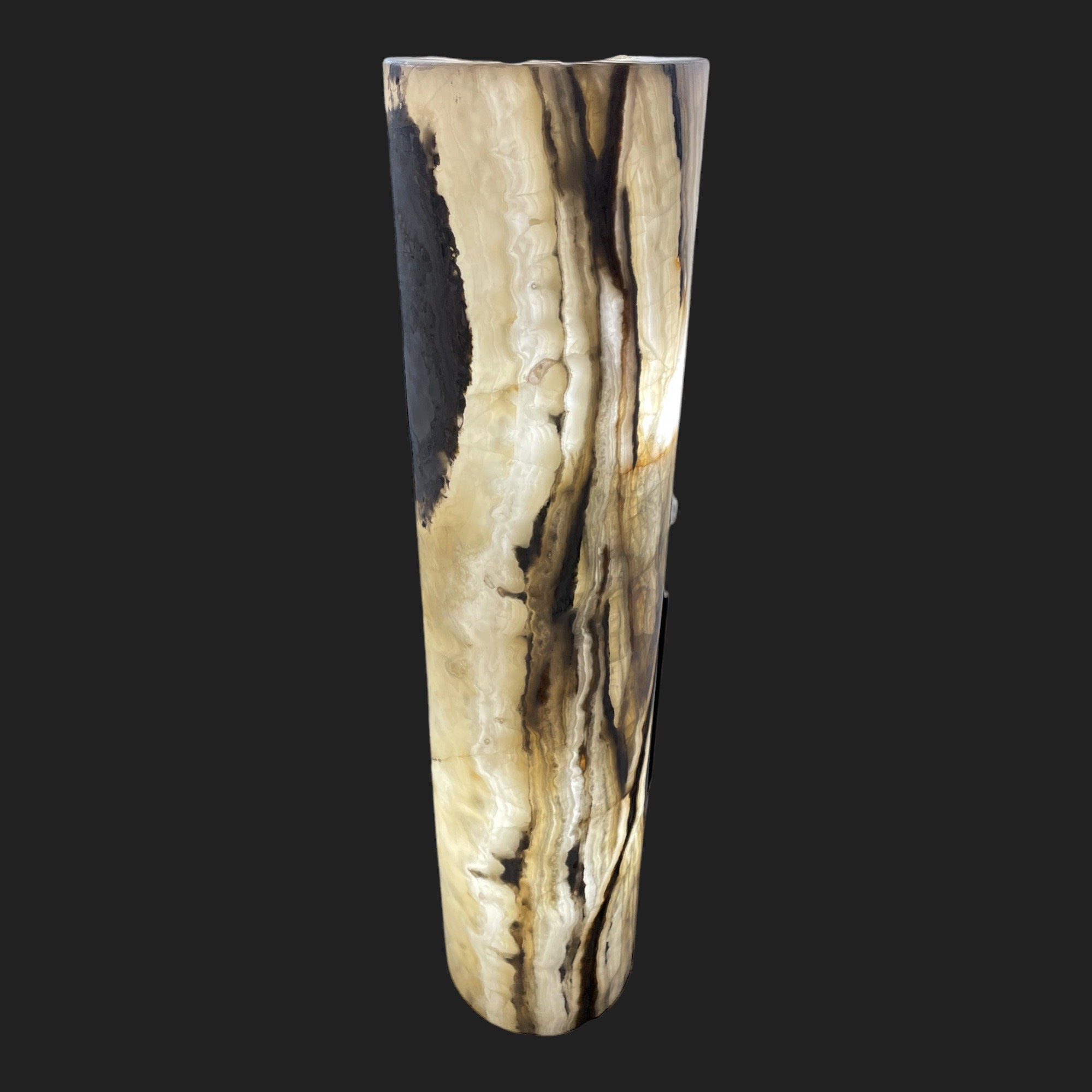Tall natural onyx floor lamp glowing with warm internal lighting