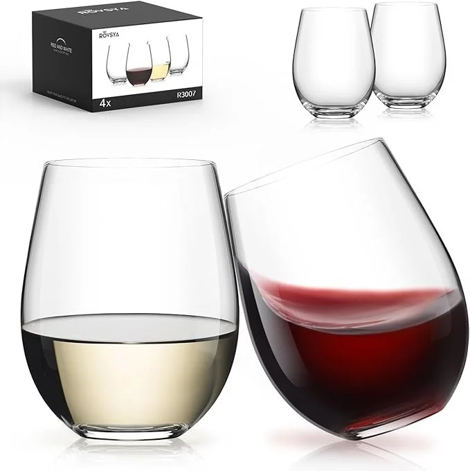 Two stemless wine glasses, one filled with white wine and the other with red wine, with a box of four similar glasses in the background