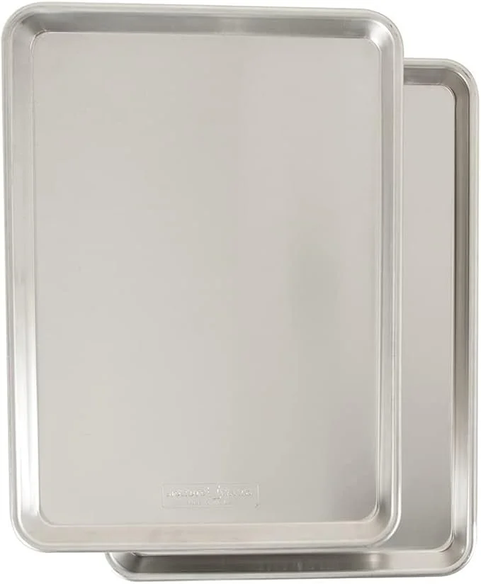 Two rectangular metal baking sheets stacked, one slightly larger than the other.