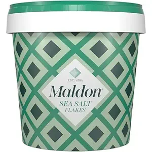 Container of Maldon sea salt flakes with green geometric pattern design.