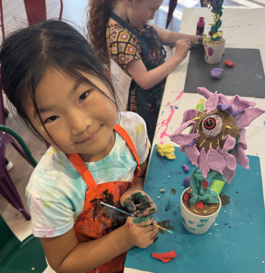 Young artist creating a colorful clay creature during a kids art class at Whimsy Wees Art Studio in Beaverton