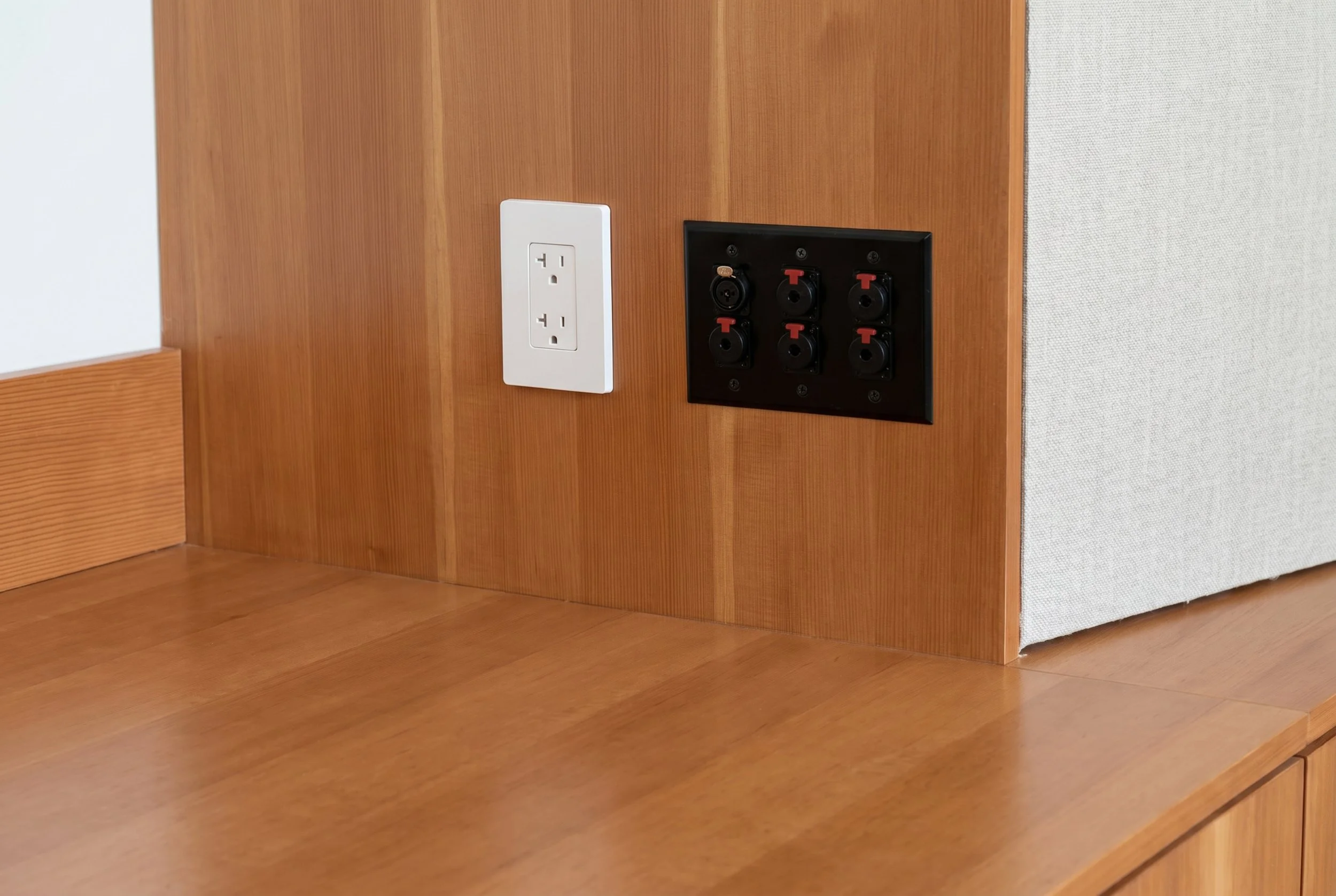 Custom Douglas fir millwork incorporates a discreet patch panel, reducing visual clutter and keeping the compact studio flexible for different recording setups.