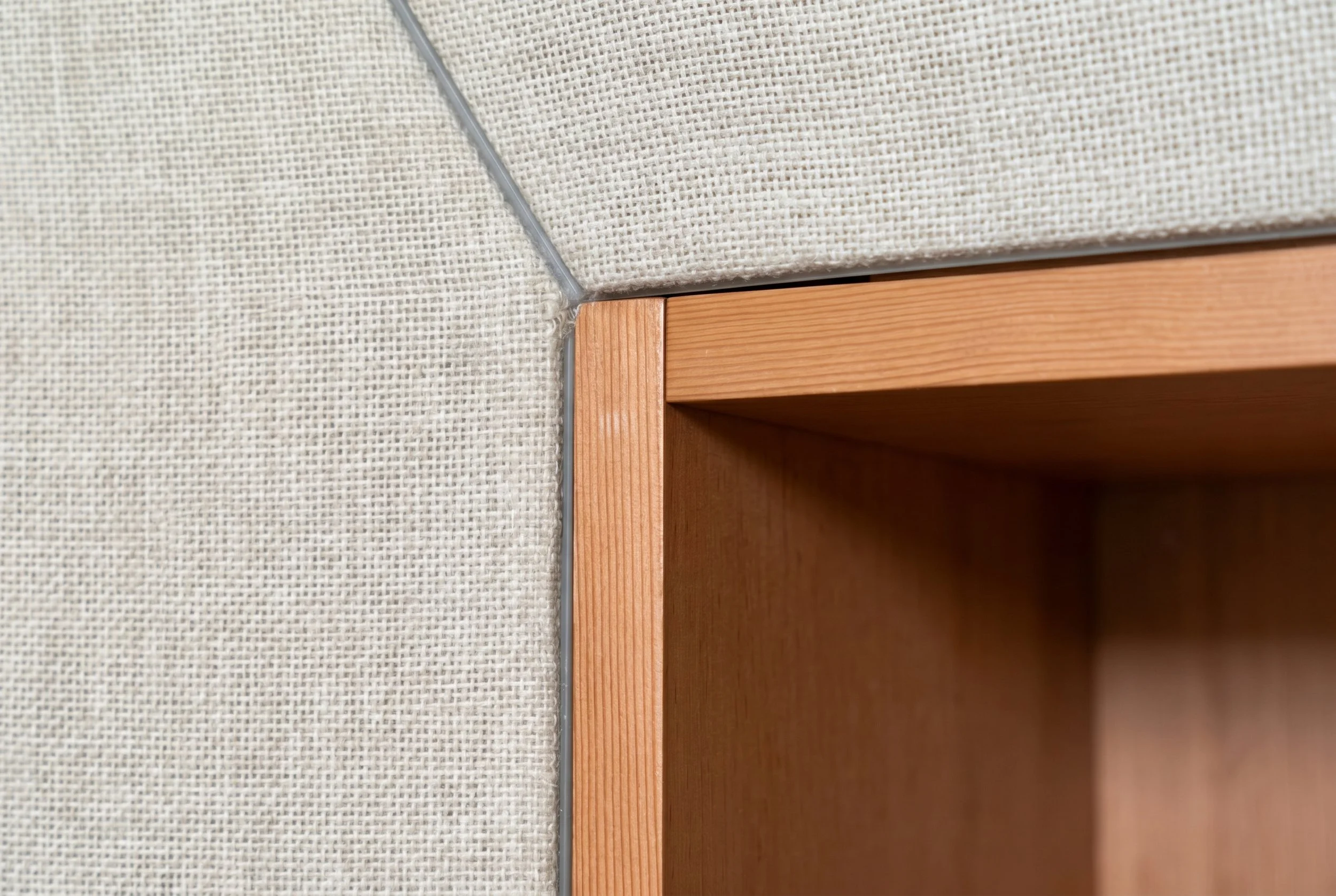 Clean transitions between Douglas fir paneling and fabric-wrapped walls reinforce the studio's furniture-like character and attention to detail.