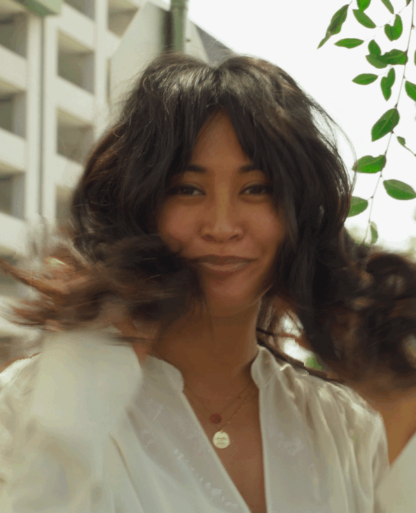 Sal Salcedo's signature layered haircut featuring soft face-framing, barely-there bangs, and natural movement.