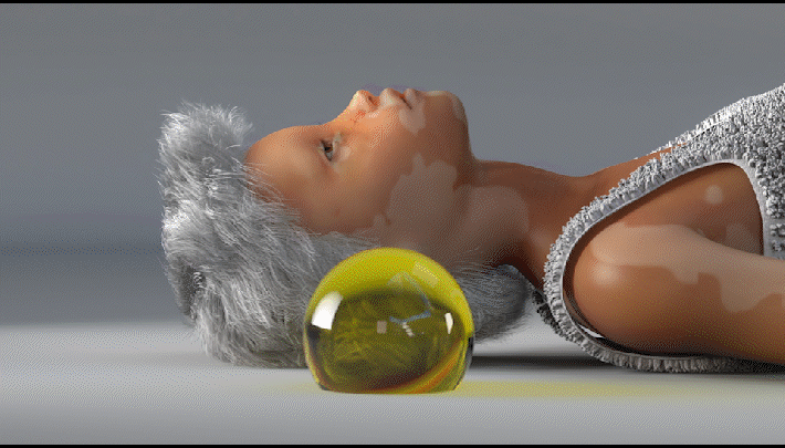 A woman with silver hair lying on her back next to a yellow glass orb, wearing a sparkly silver dress, with a plain gray background.