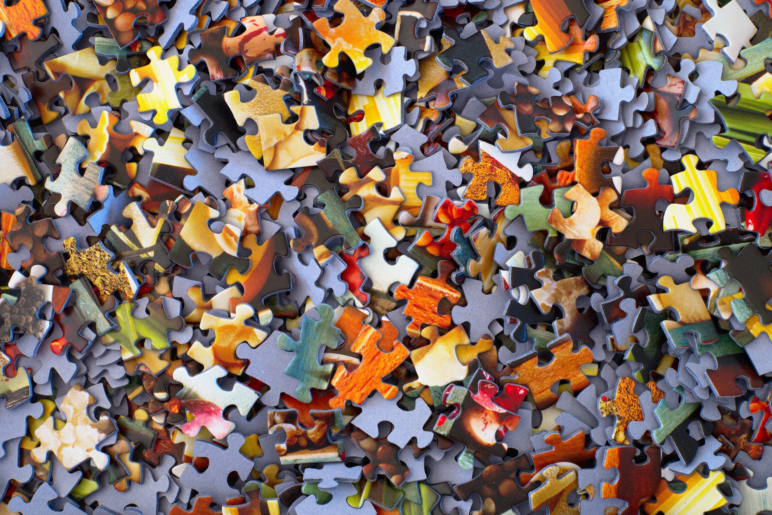 Colorful scattered jigsaw puzzle pieces