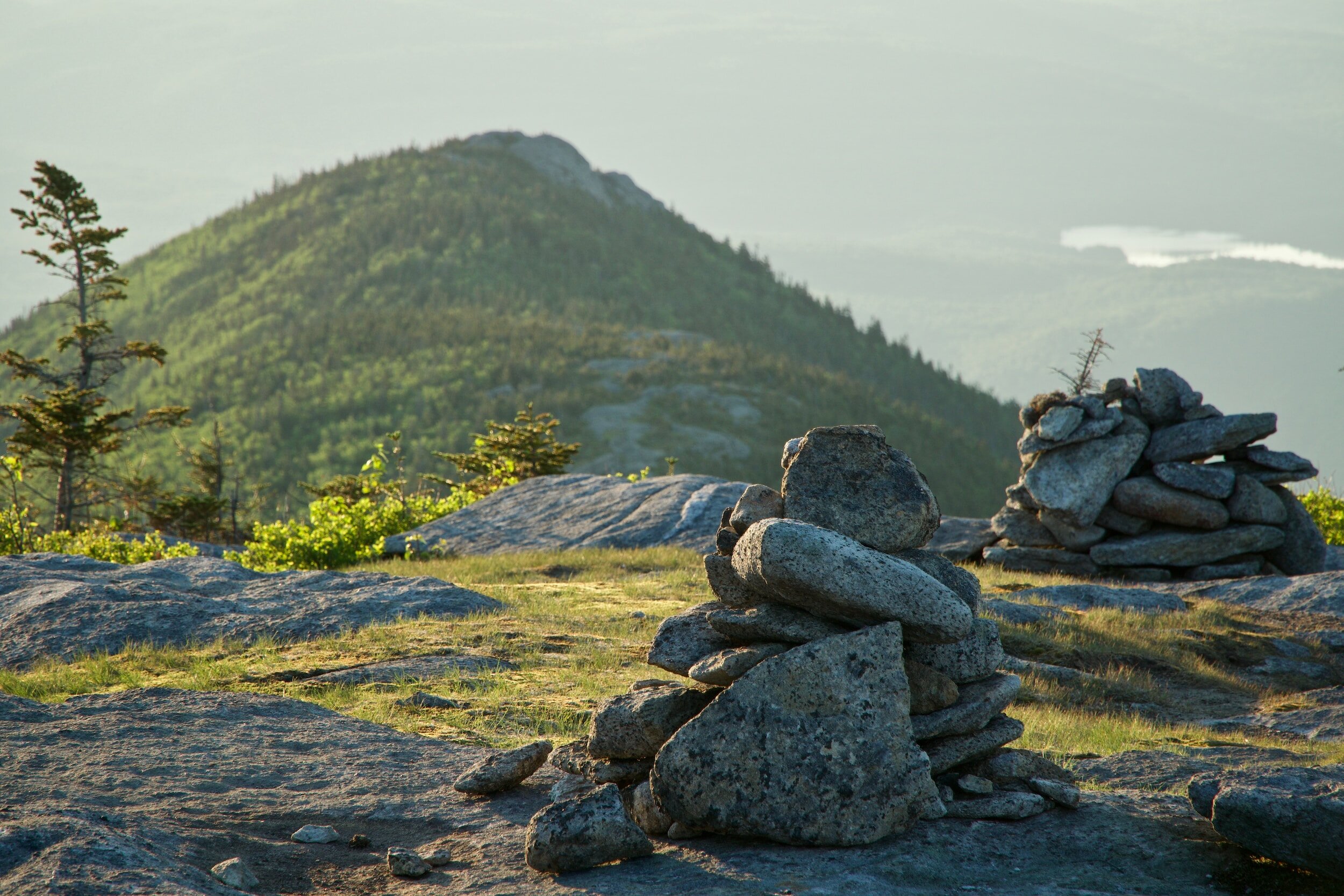Mountain landscape with cairns and lush forest